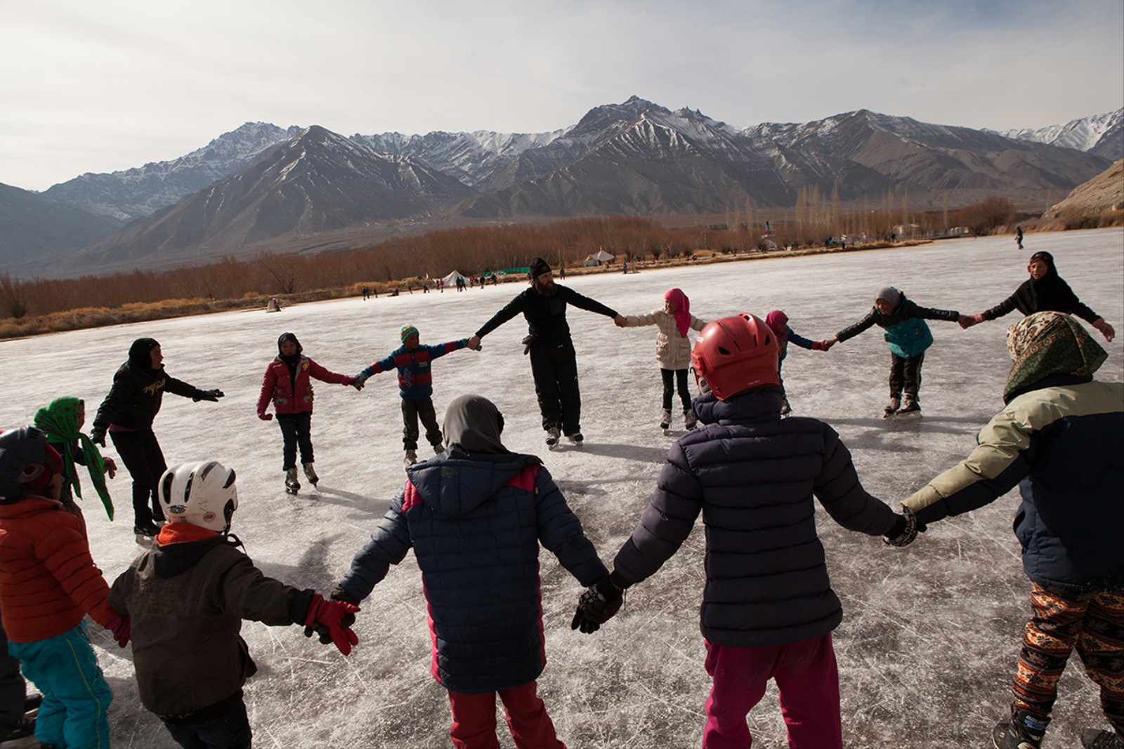 1484412089084 Children from Thangnak village on the ice with coach Ian Andersen