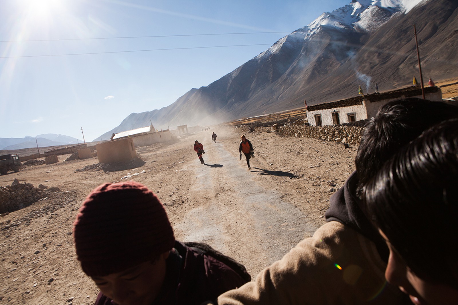 1484412250405 Eager to start hockey practise the children is running through the village of Kargyam on their way to the pond