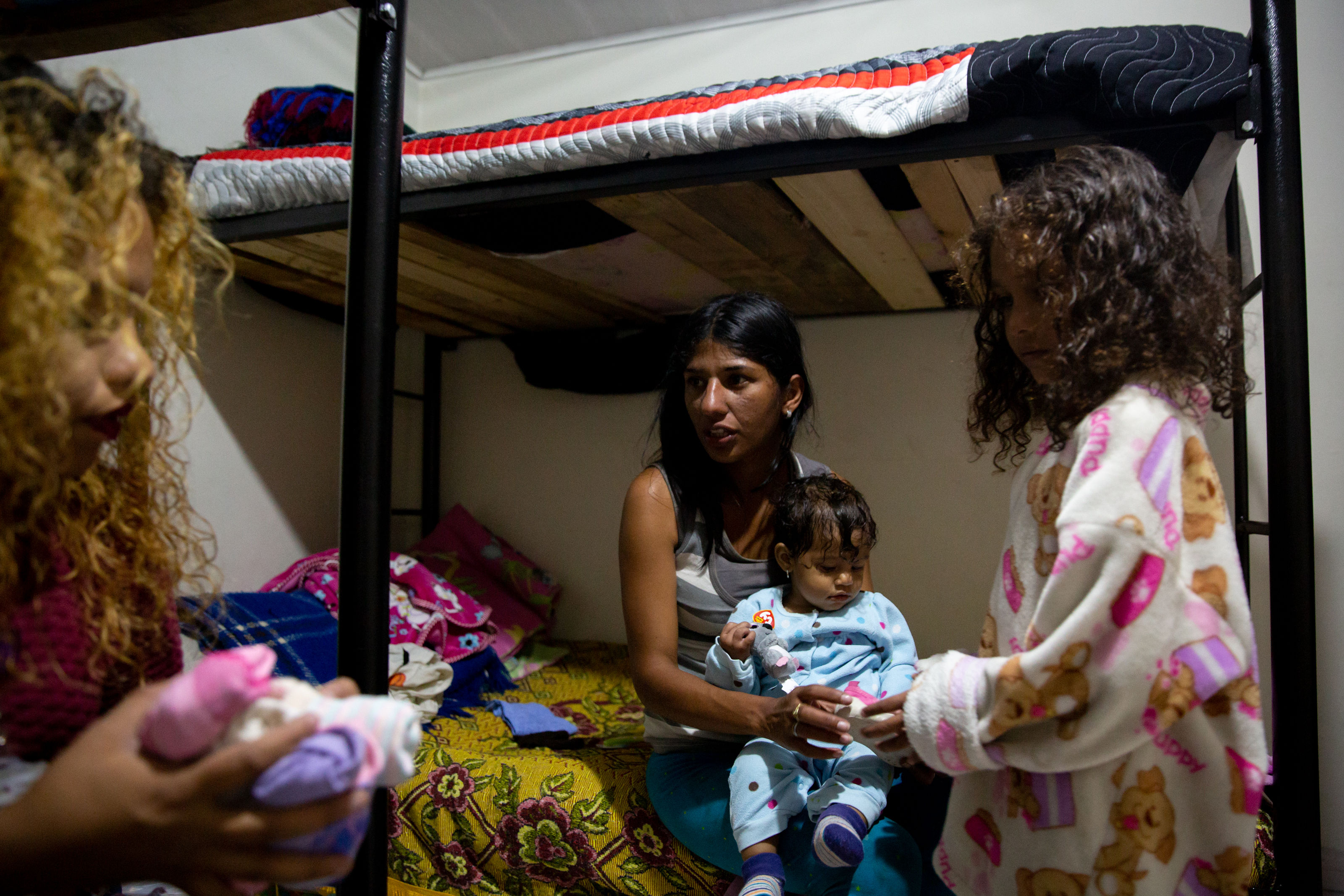 Alejandra Agrinzones, 22, receives clothing donations for her children during her stop at the Holy Spirit Refuge in Tunja.