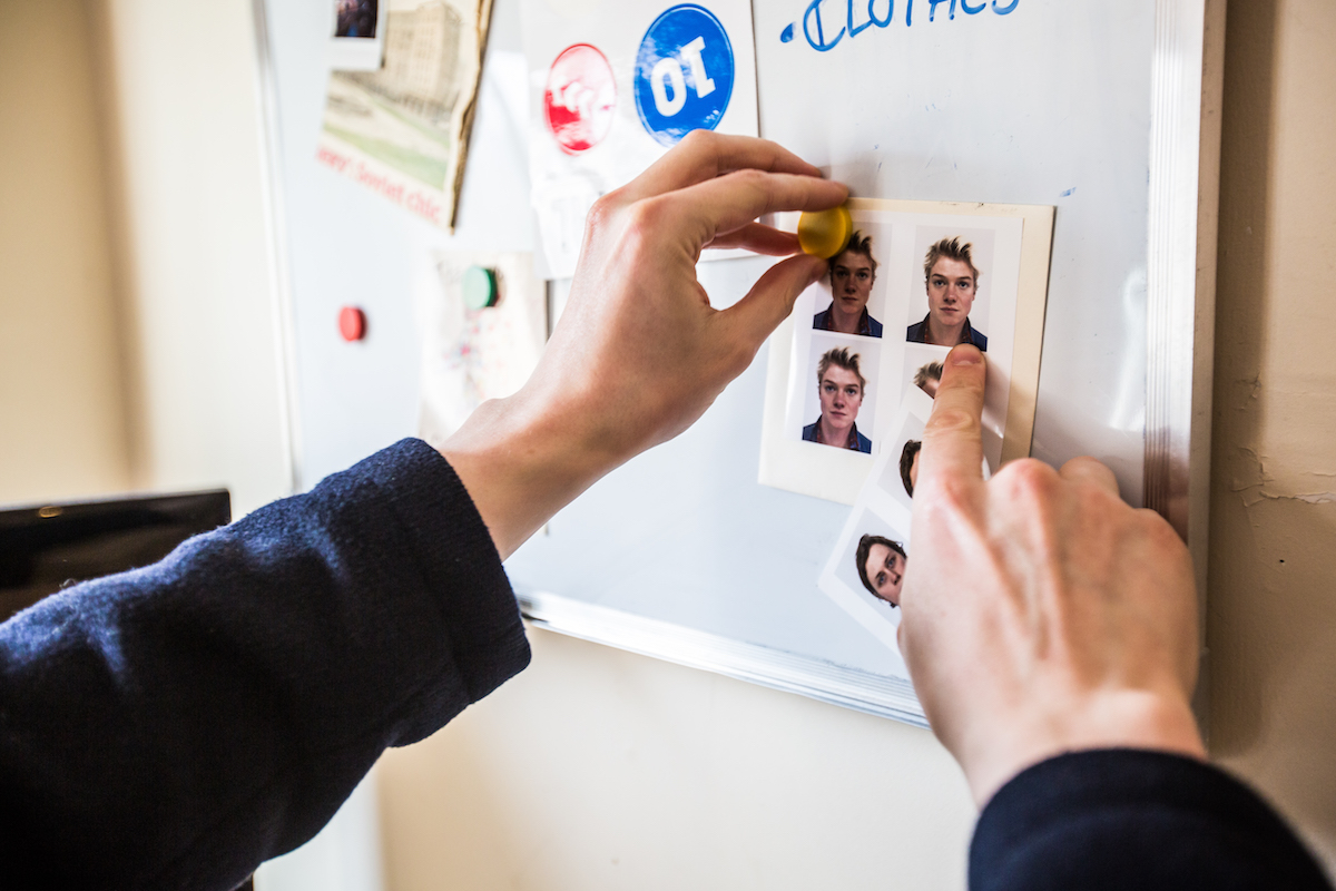 photo booth photos pinned on wall