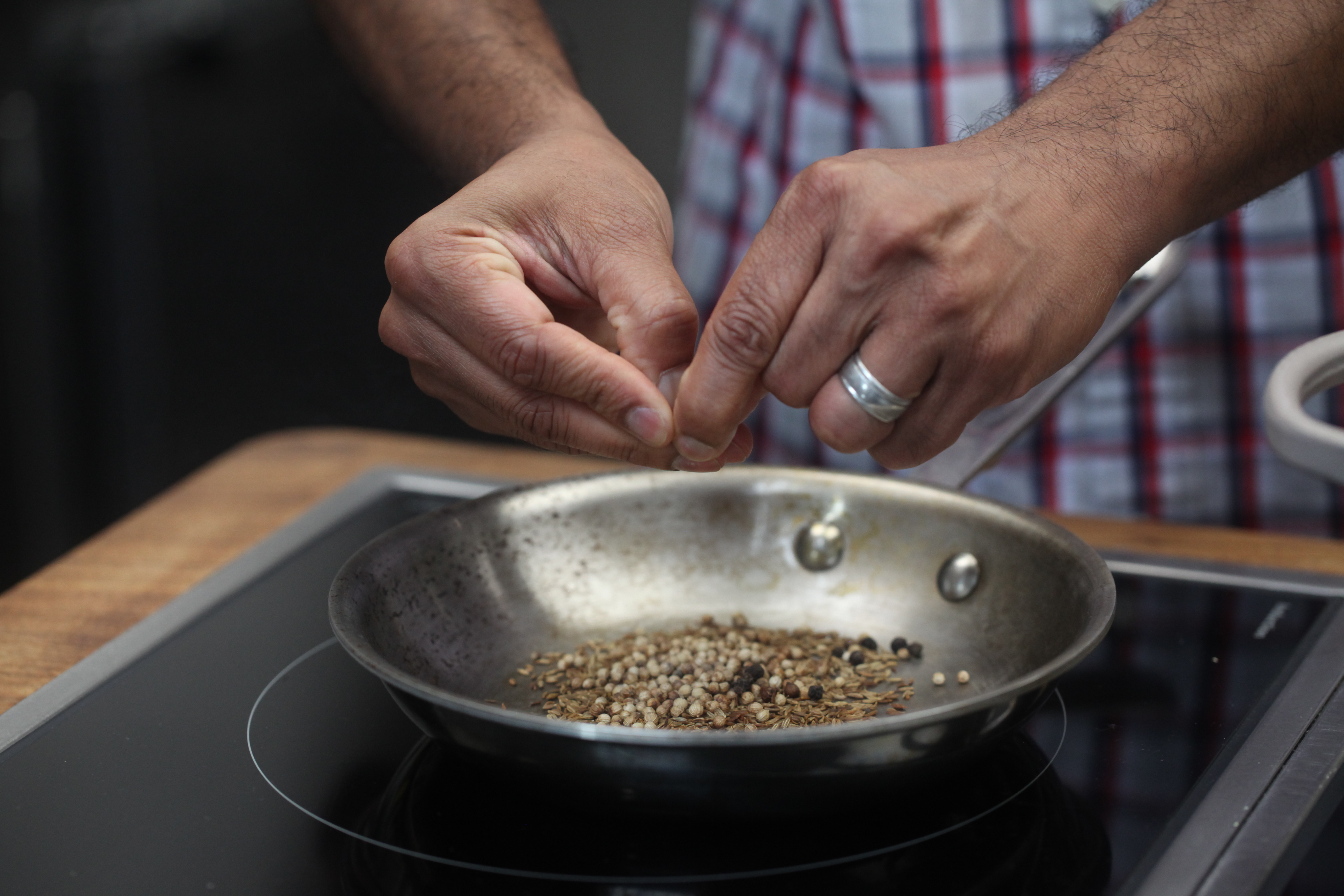 Hands prepping spices