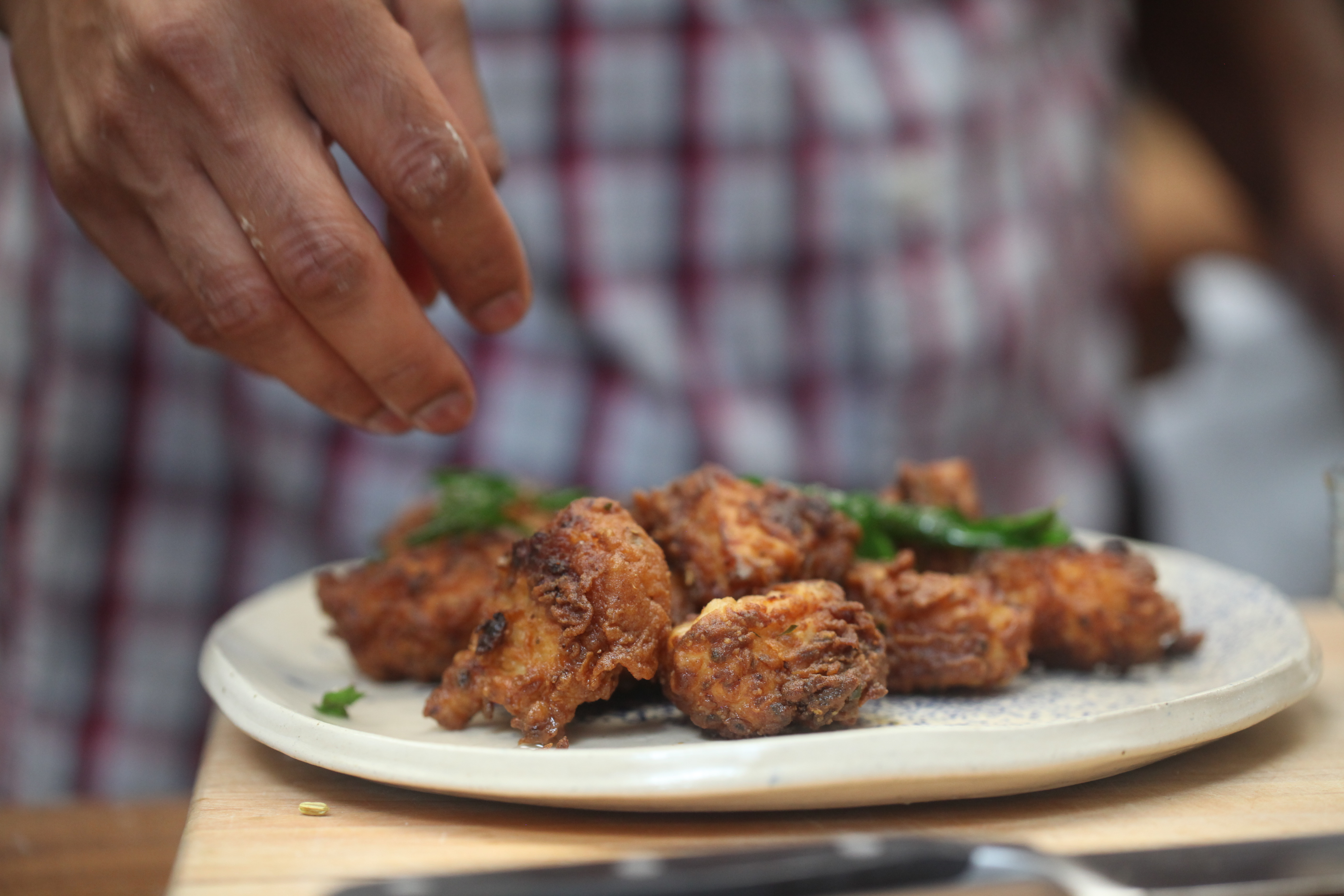 fried chicken garnished with curry leaves