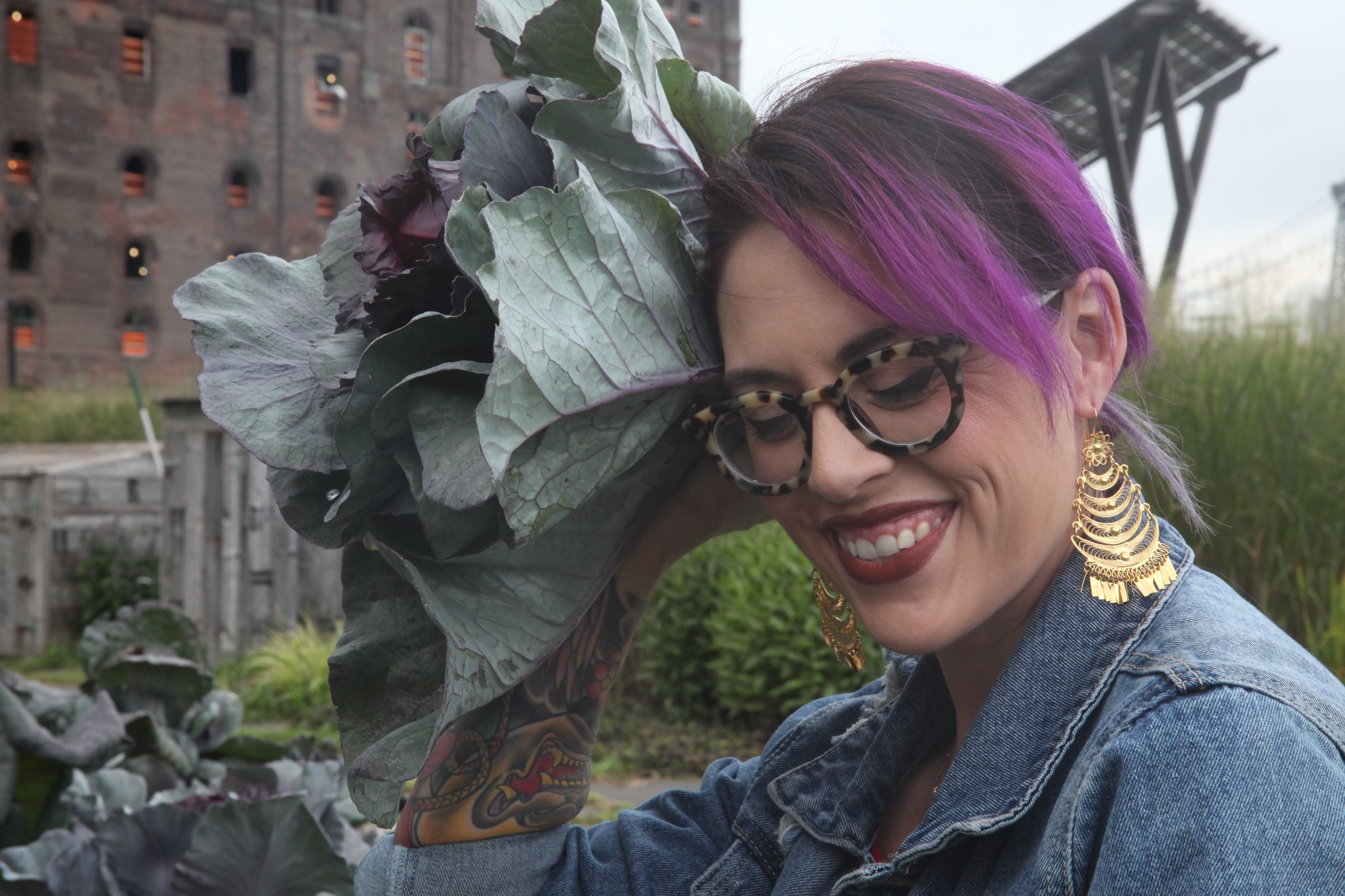 Claudette Zepeda-Wilkins holding red cabbage as if it is a flower in her hair