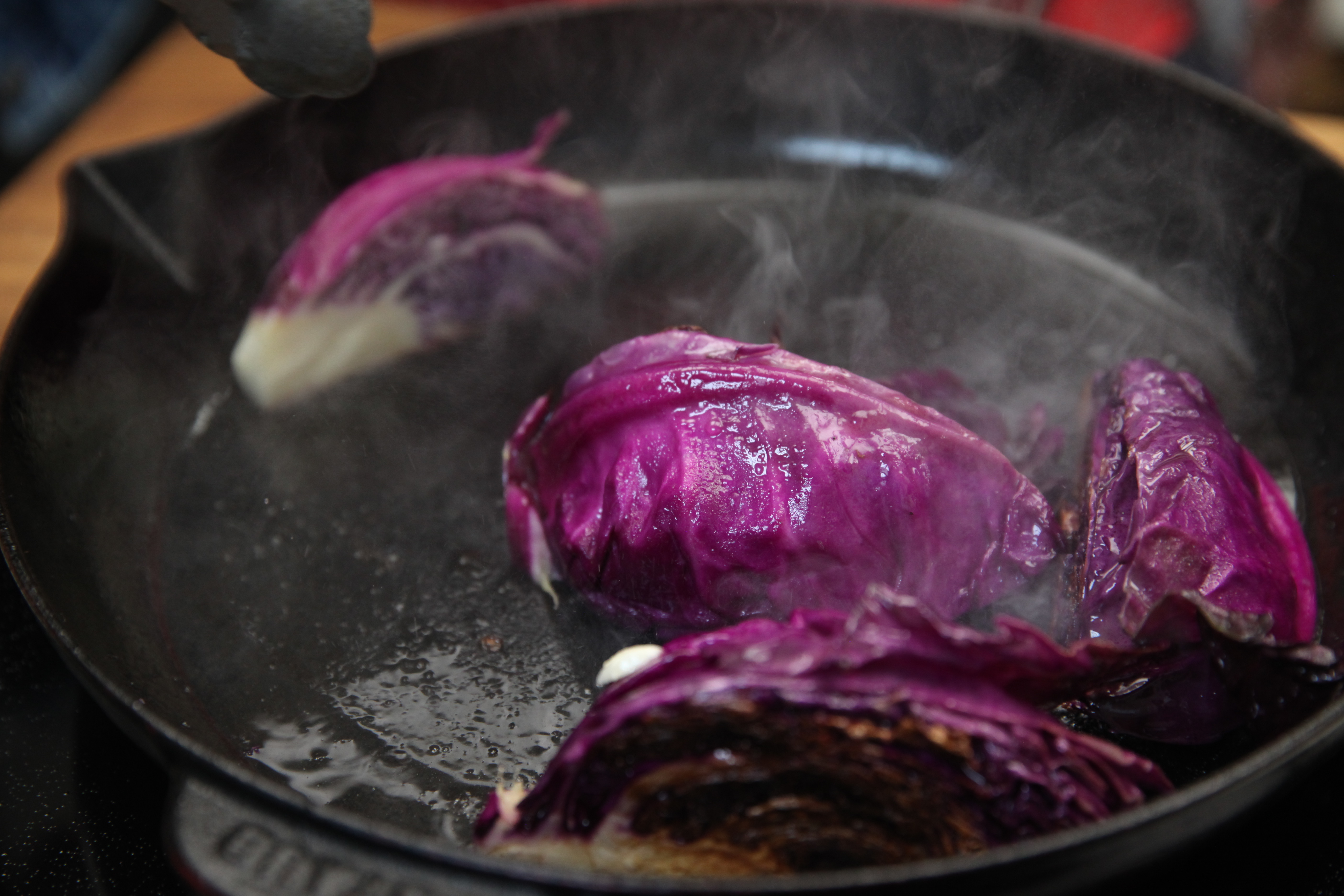 Cabbage wedges grilling in cast iron skillet