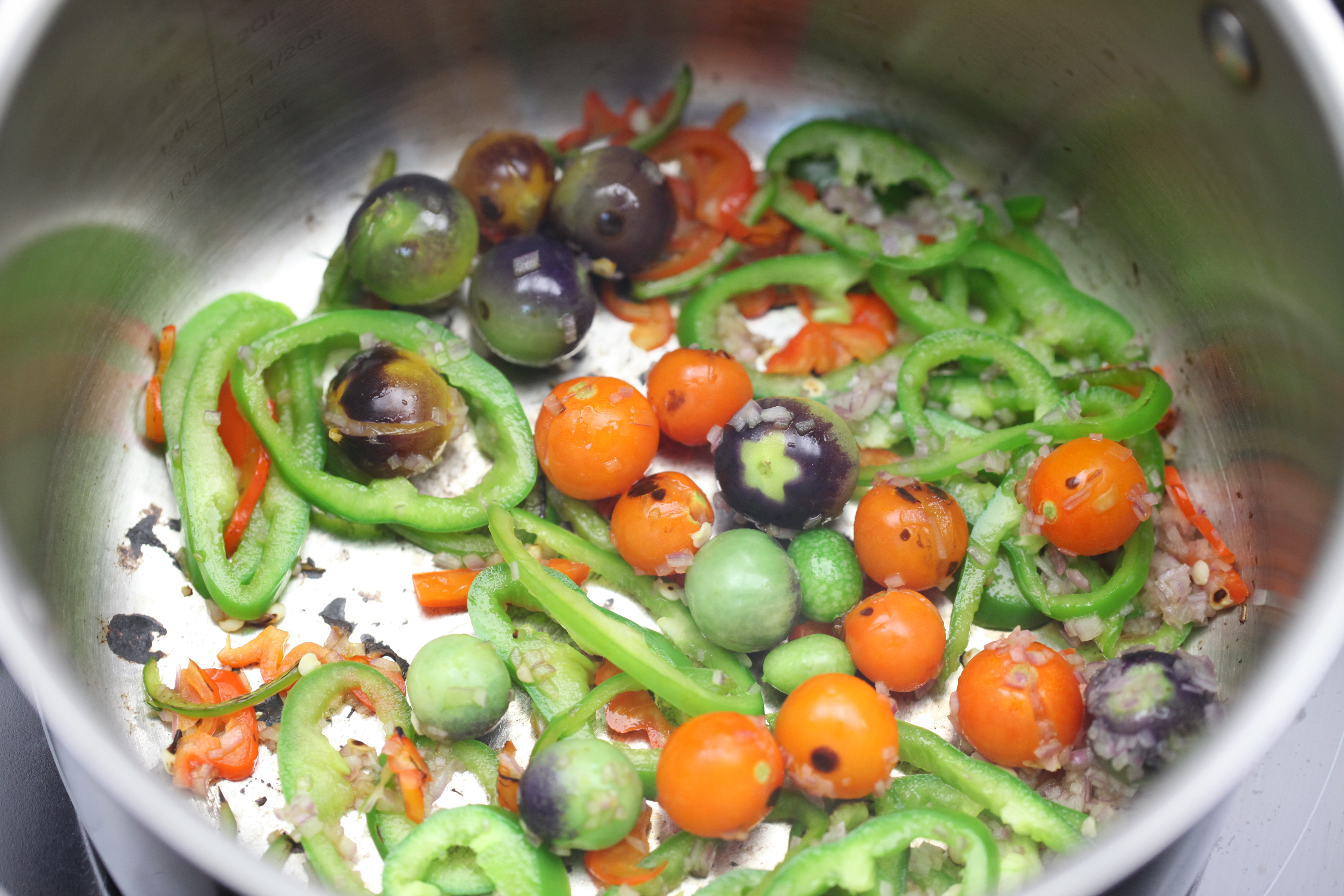Tomatoes, shallots, Anaheim peppers in sauce pot