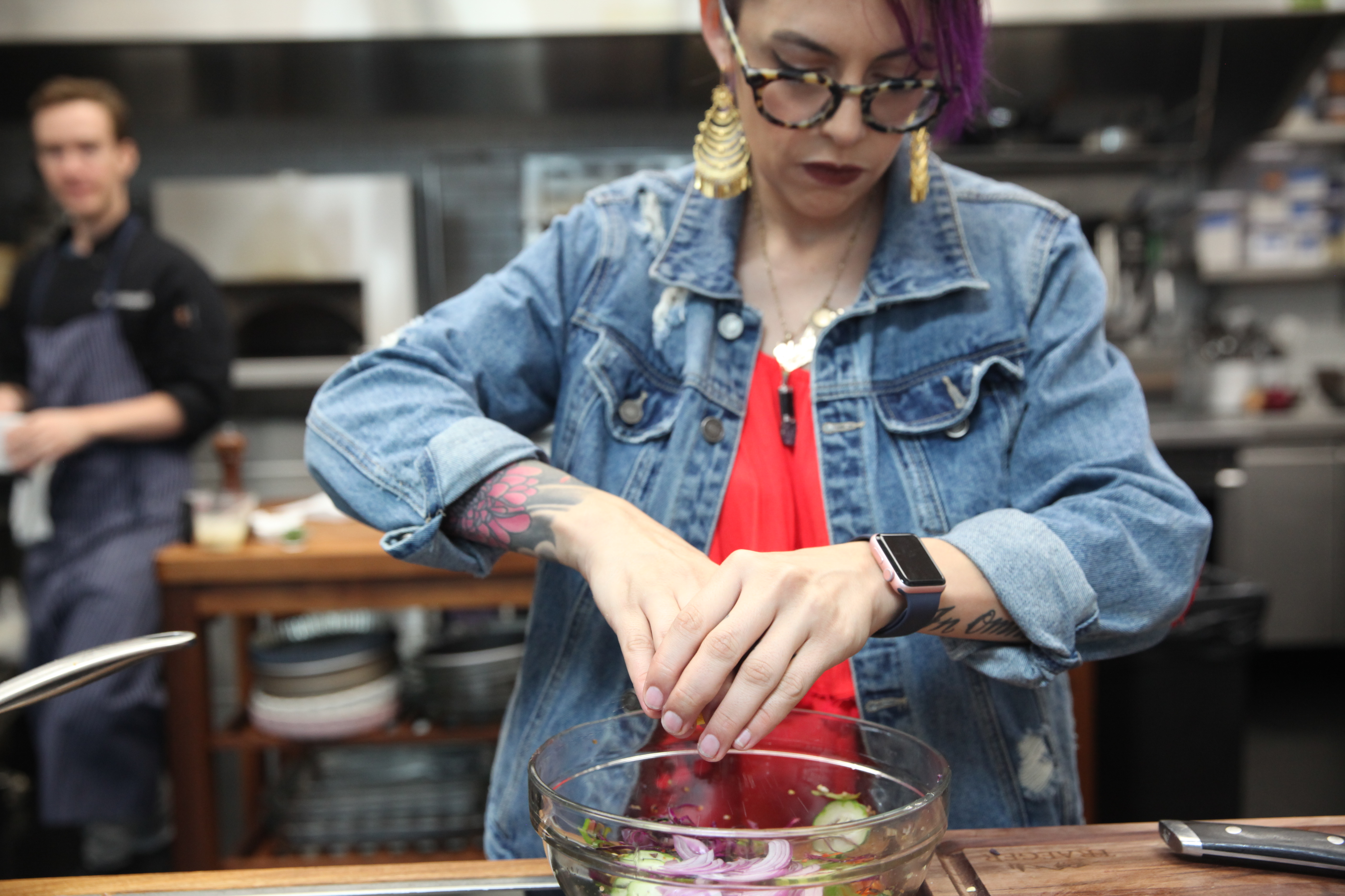 Claudette Zepeda-Wilkins squeezing lemon juice over cabbage slaw