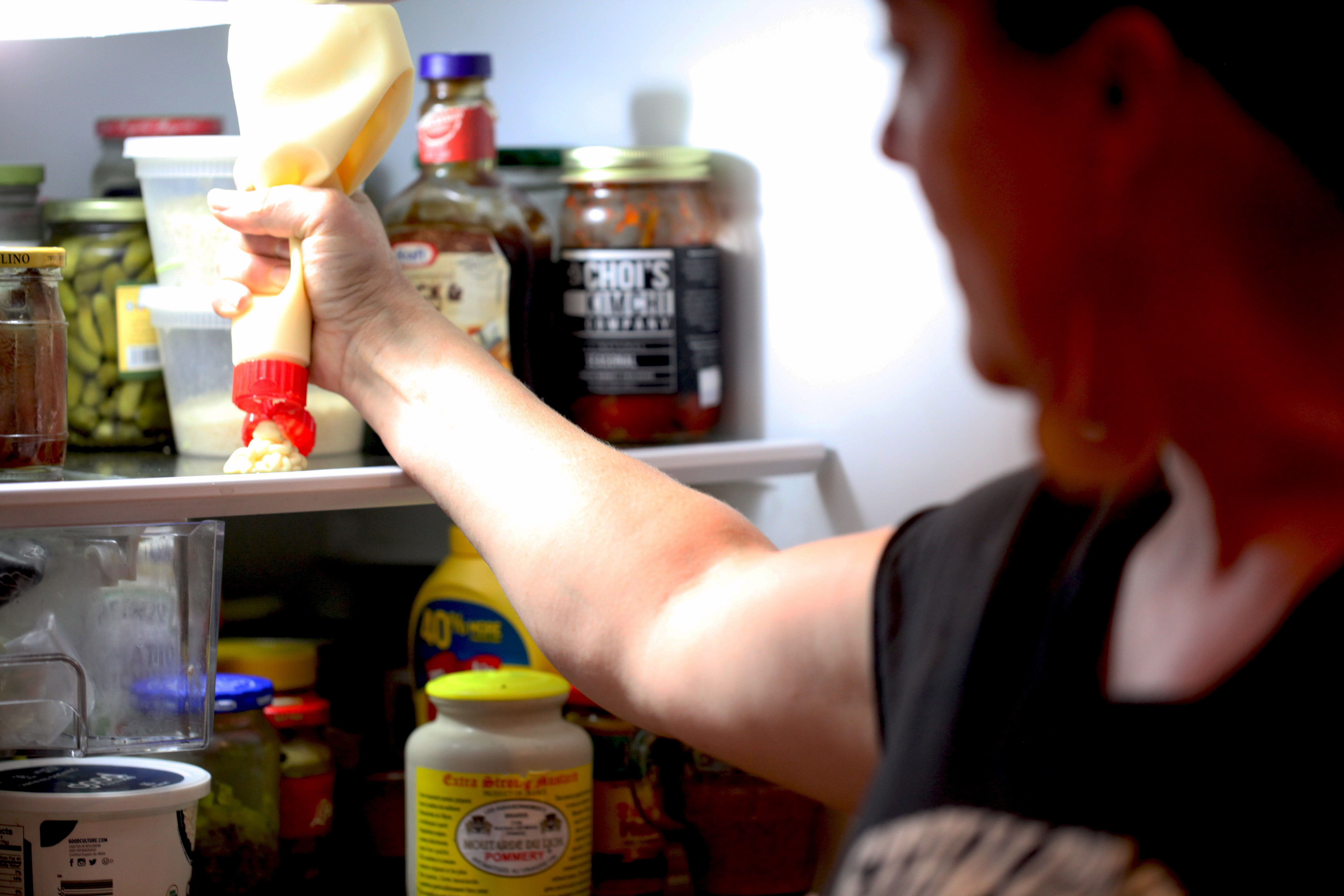 Naomi Pomeroy squirting kewpie mayo in her fridge