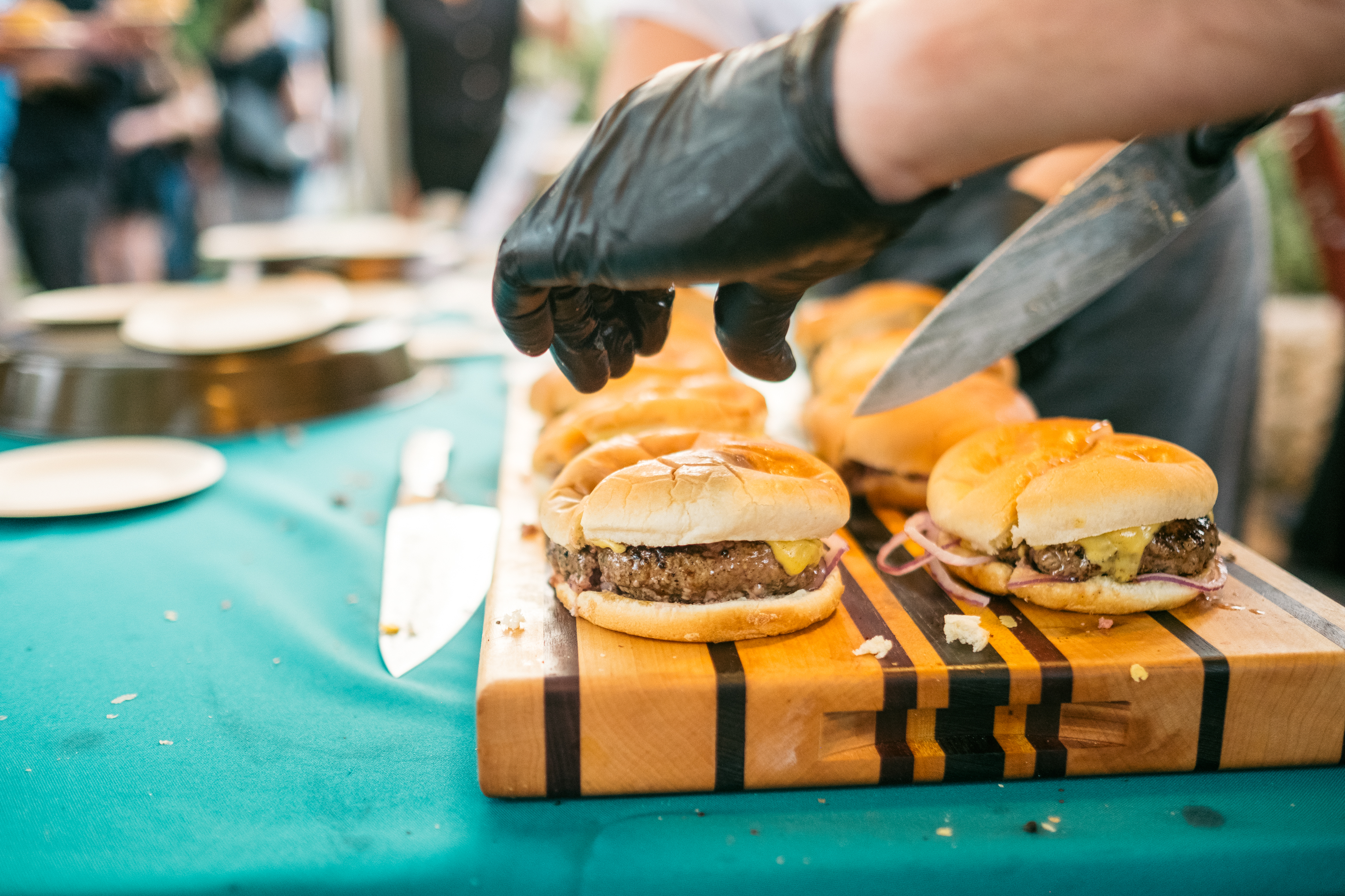cheeseburgers on a cutting board.