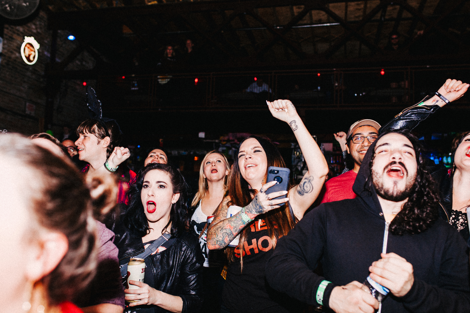 The crowd cheers and watches the MudQueens wrestling match at Reggies Rock Club, October 30, 2018.