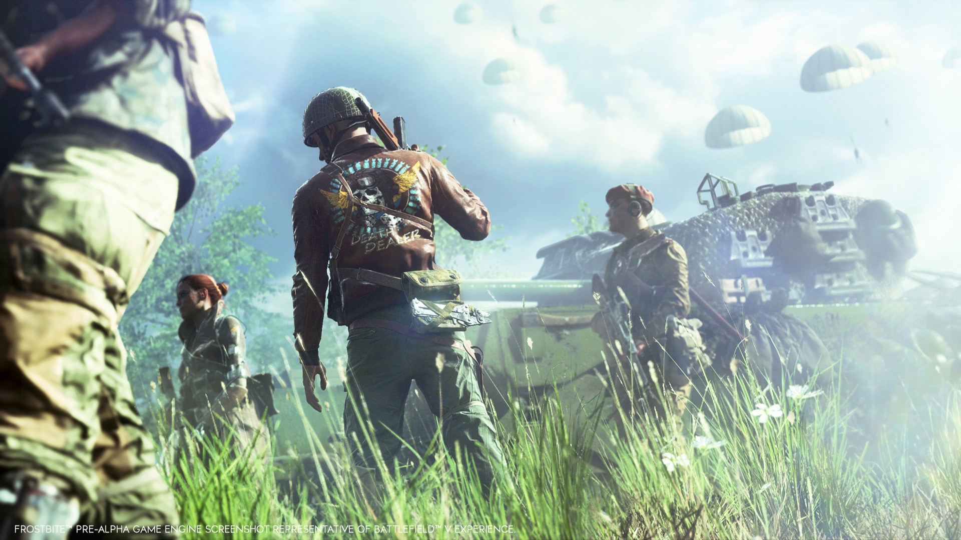 A group of British troops in snazzy non-regulation uniforms stand tall in green grass on a summer's day in a distant field, with a tank in the background.
