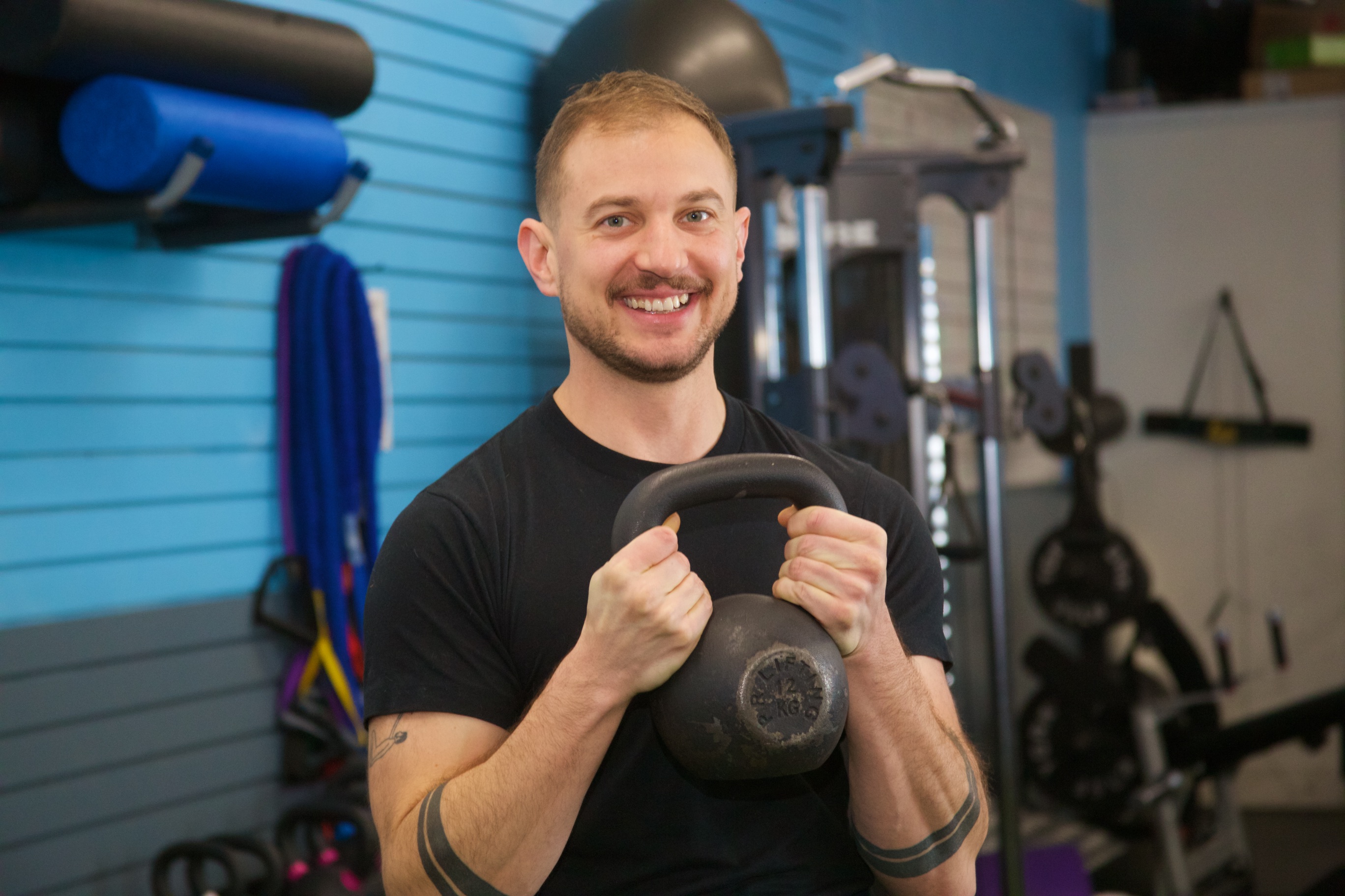 a man lifting a kettlebell