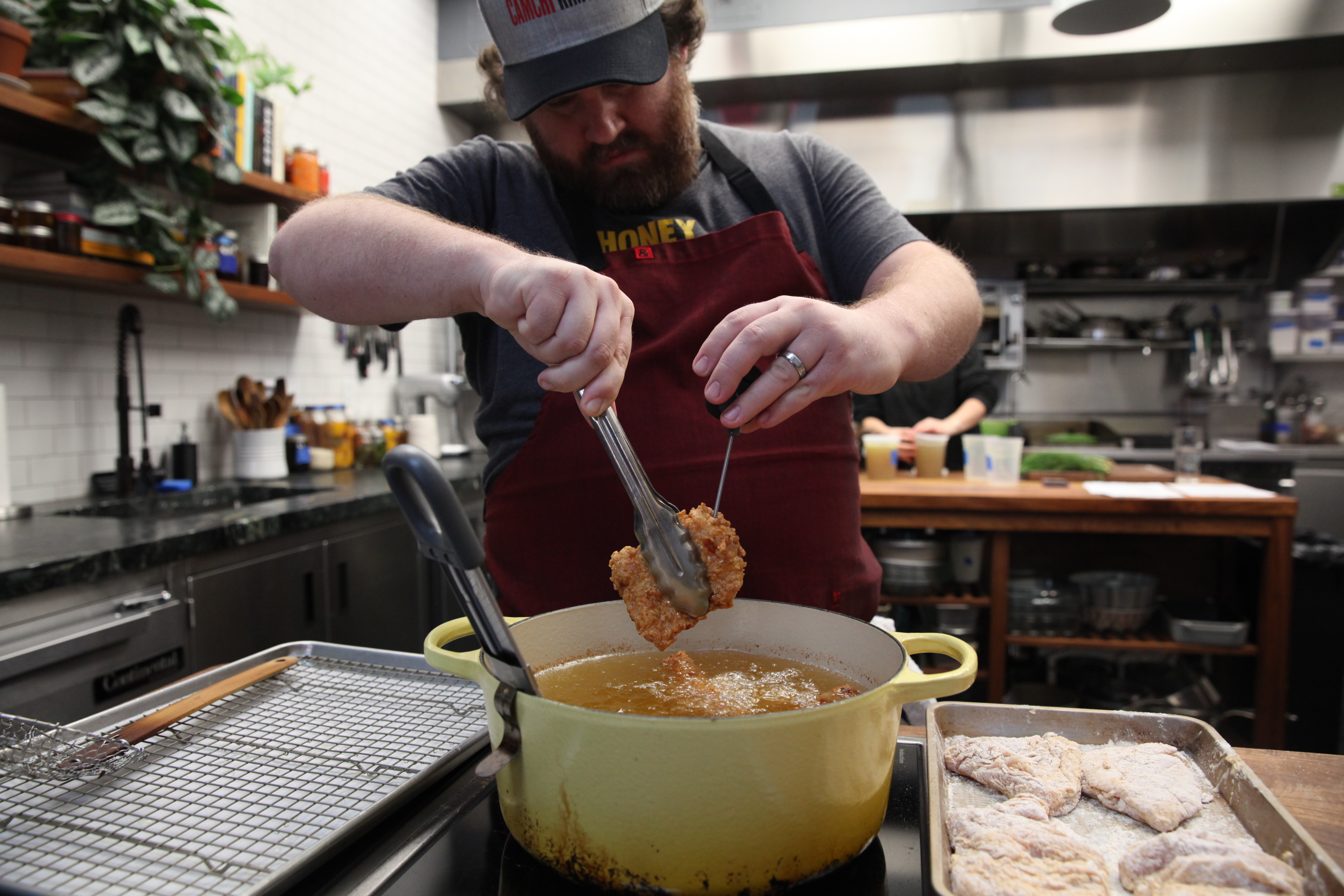 cam waron checking temperature of fried chicken