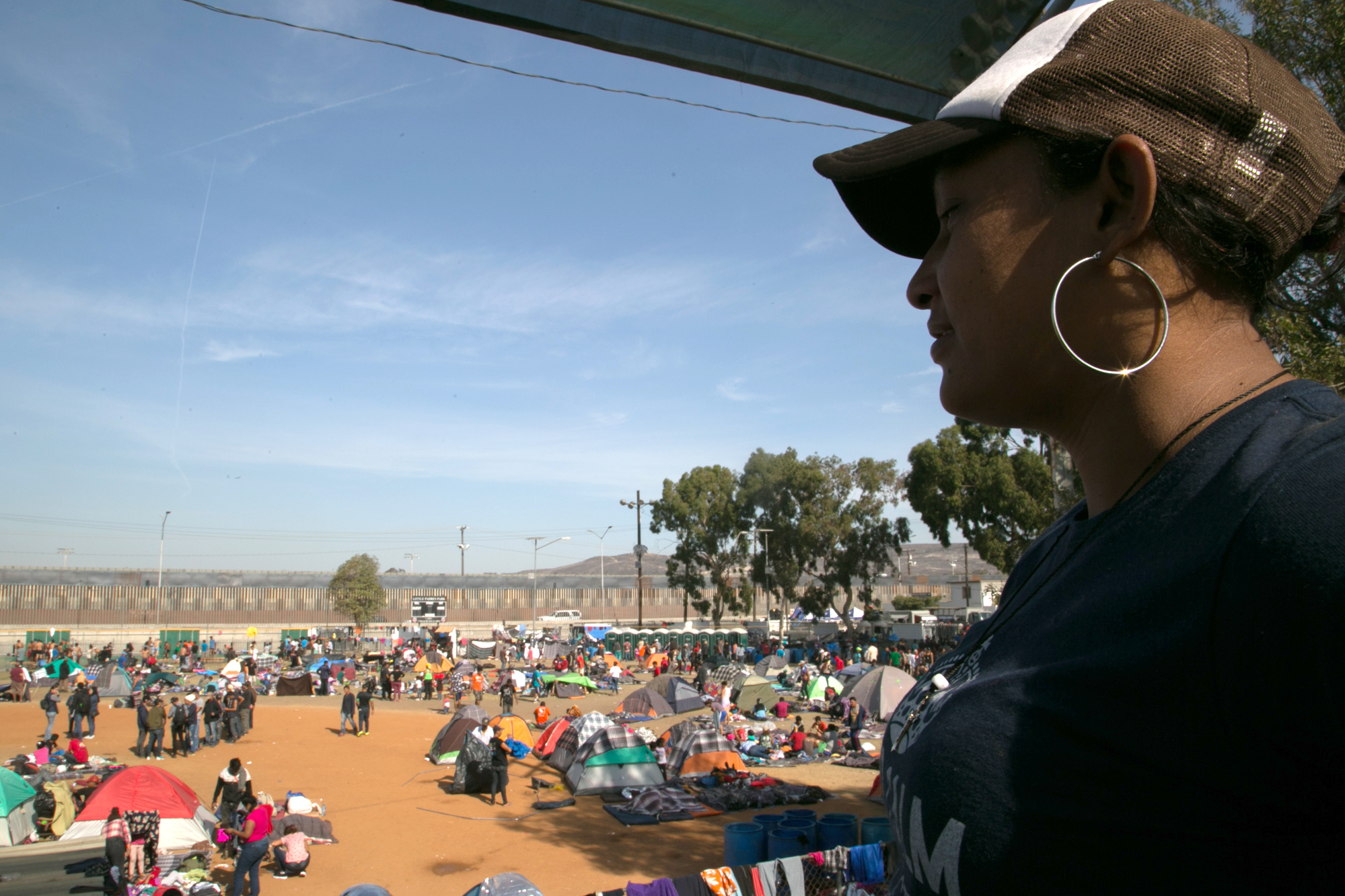 Woman from the migrant caravan looks over a camp in Tijuana, Mexico