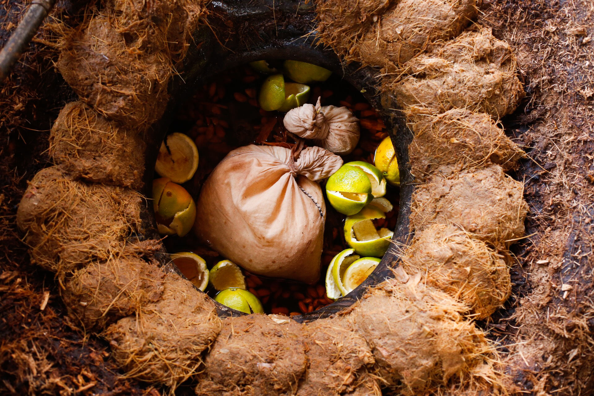 Ingredients for pechuga in a clay pot still, soon to be sealed with agave pulp.