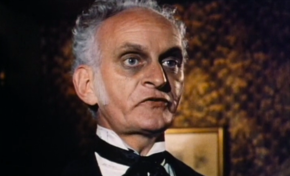 An old man with dark eye makeup