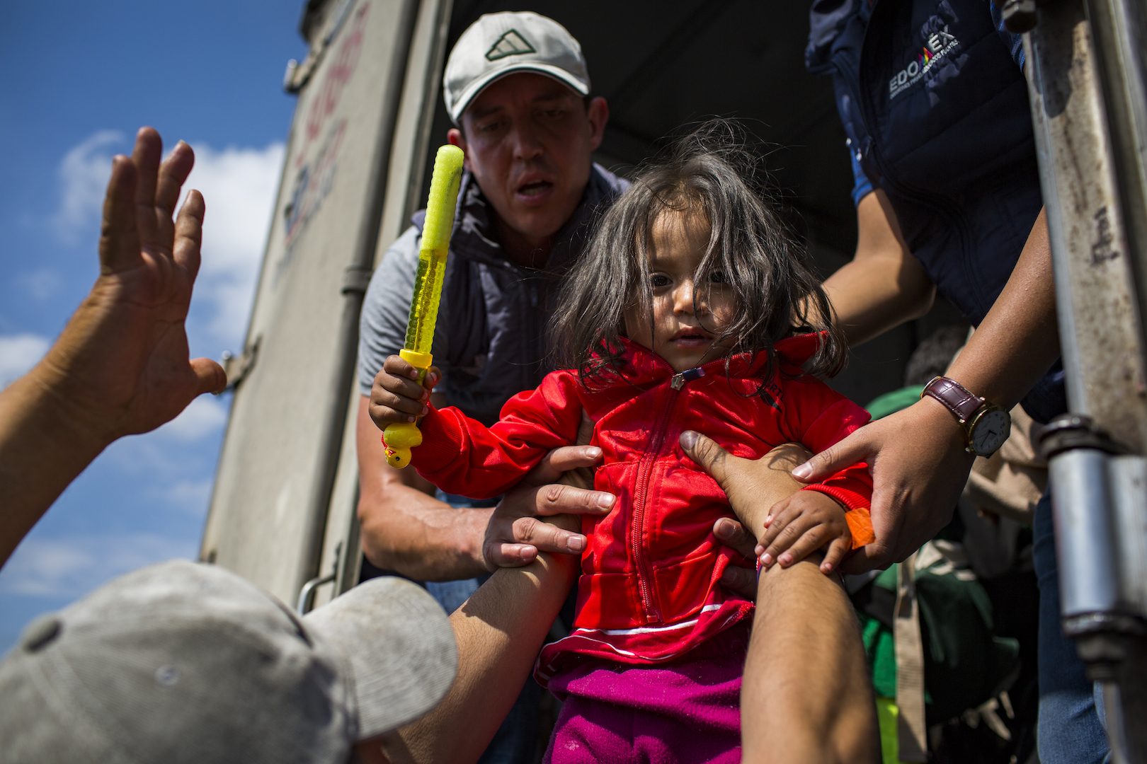 To move migrants our of Mexico City an on to their next destination, state workers helped migrants get rides in the back of cargo trucks. (State of Mexico, Mexico)
