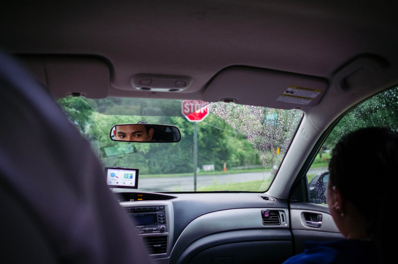 Man looking in the rearview mirror