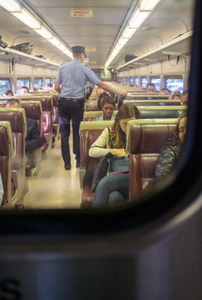 Conductor taking train tickets