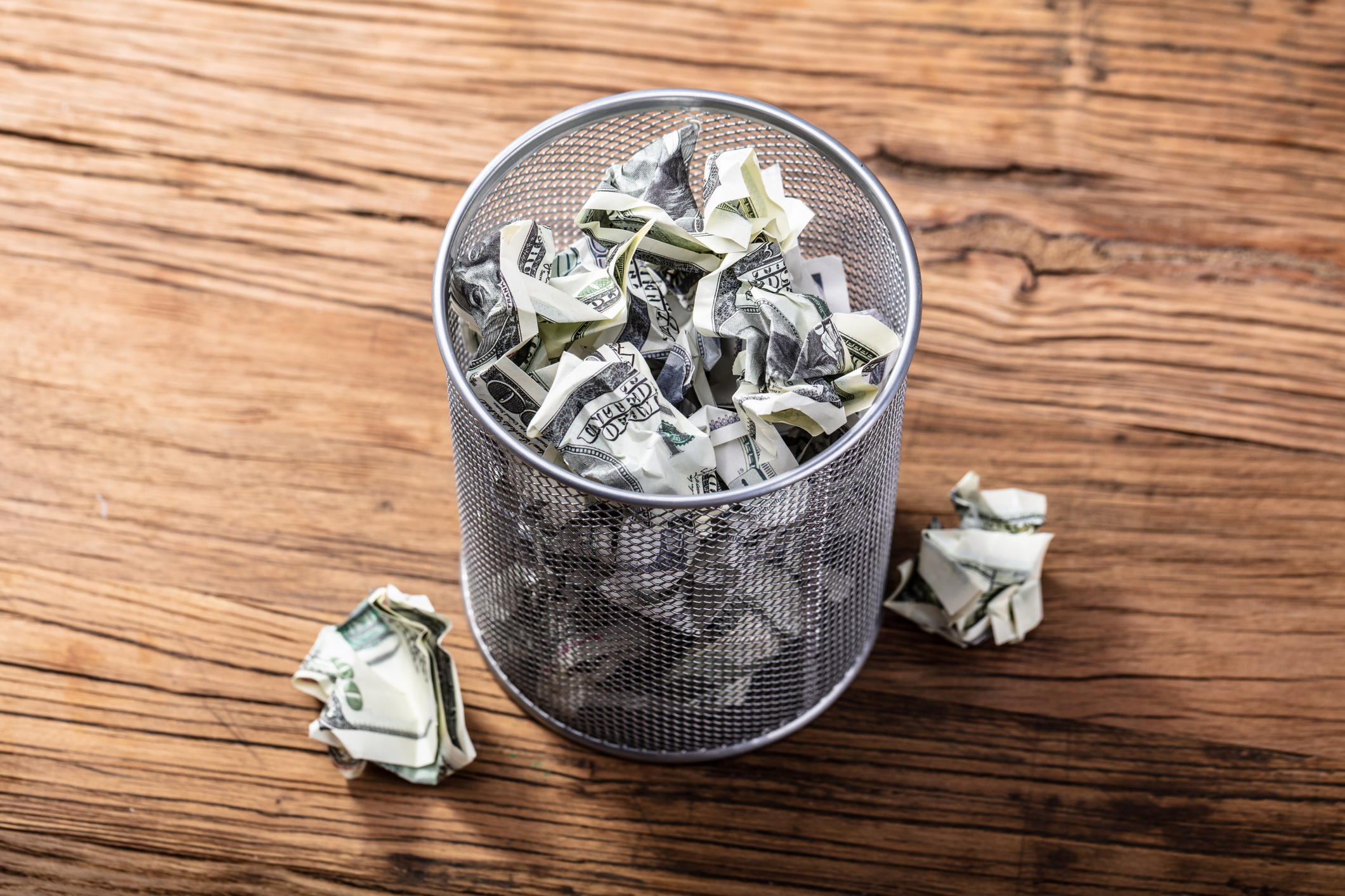 Getty Images trash can with money.