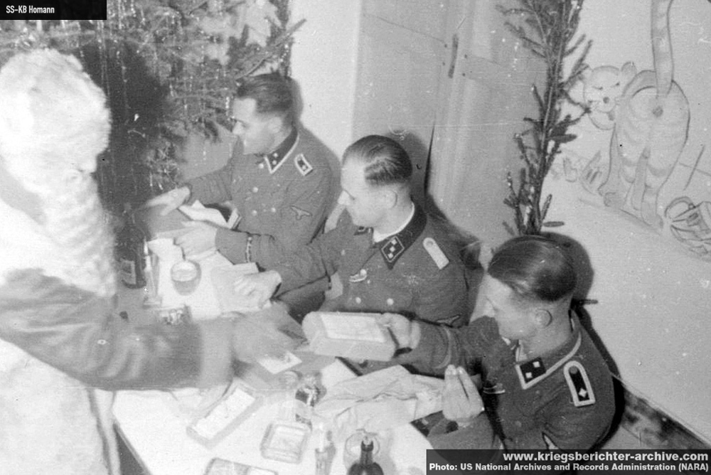 1547028612823-Esesovci-proslavljaju-novu-1943-godinu-negde-u-Beogradu-dok-ih-zabavlja-jedan-od-njih-prerusen-u-Deda-Mraza-koji-im-deli-poklone-uocavaju-se-skaredno-iscrtani-zidovi