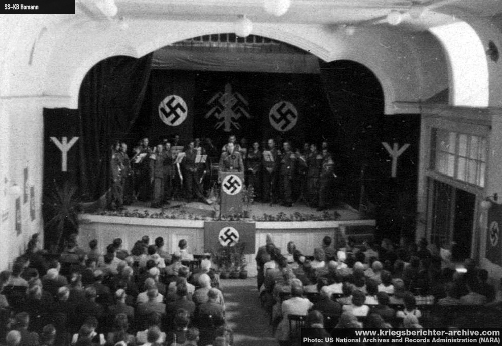 1547028699706-koncert-SS-orkestra-na-nepoznatoj-lokaciji-u-okolini-Beograda-moguce-u-Pancevu-sala-je-ukrasena-runama-pseudomitskim-motivima-izmisljenim-za-lazni-istorijski-imidz-SS-formacija
