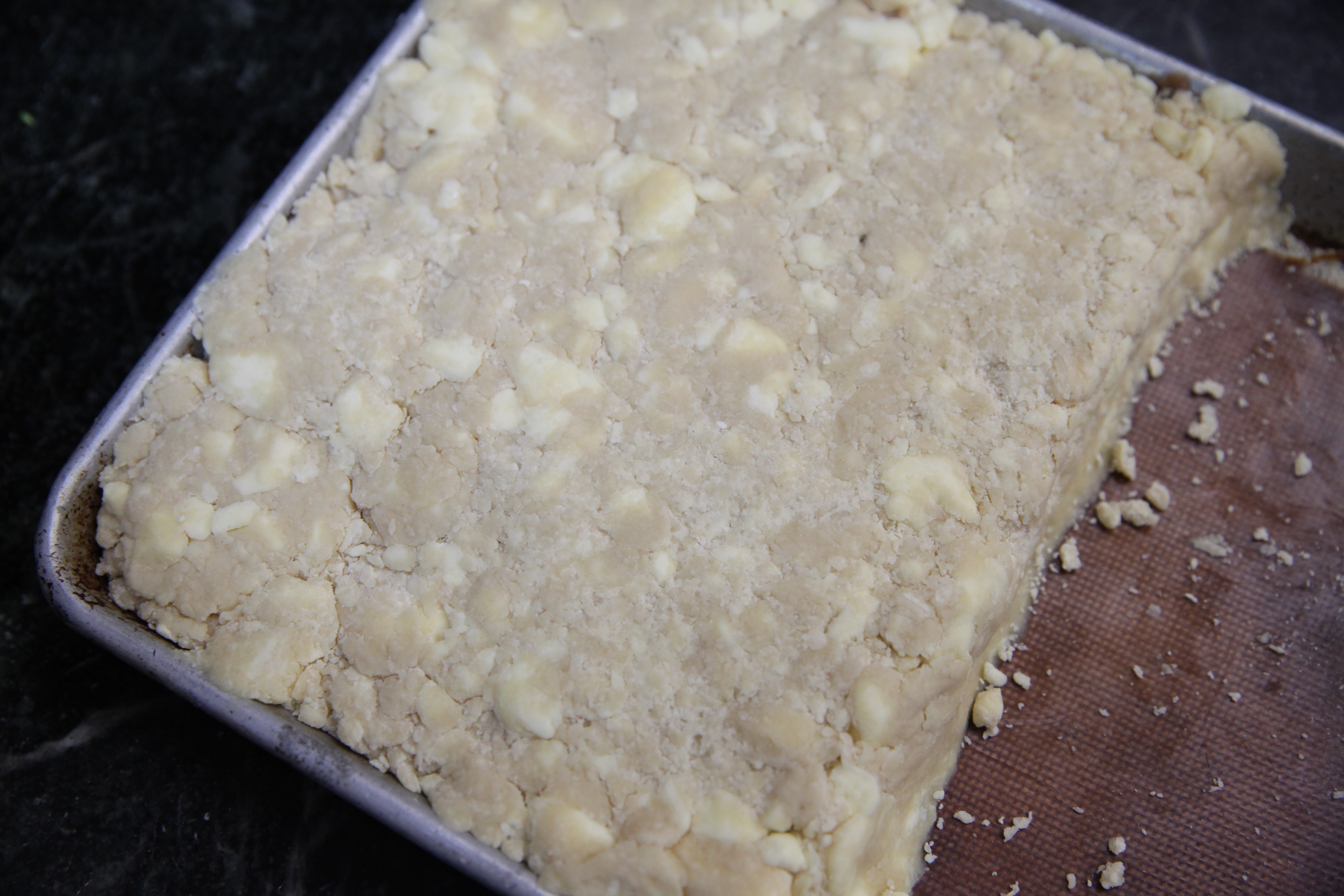 rolled out biscuit dough with big chunks of butter