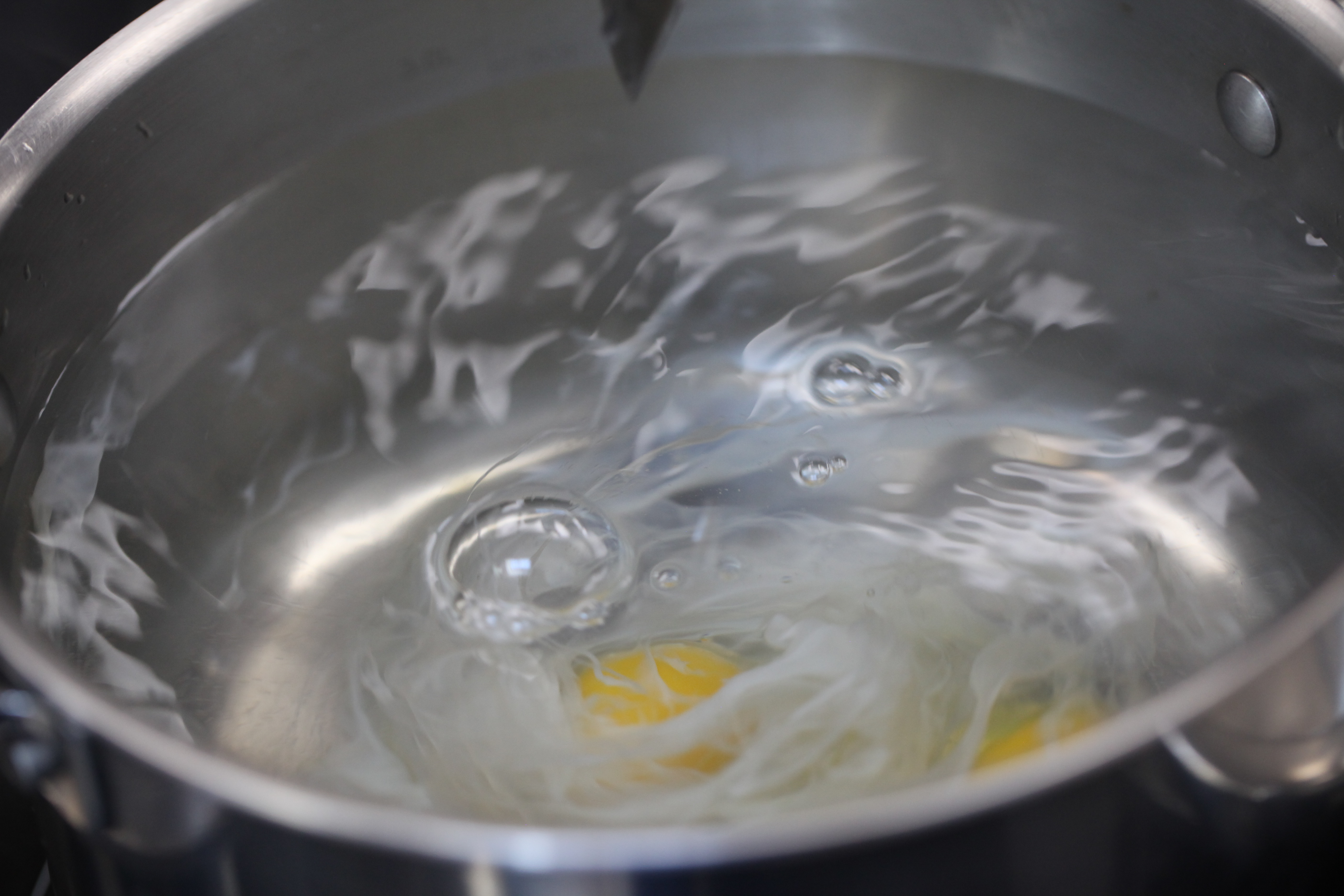 egg poaching in simmering water
