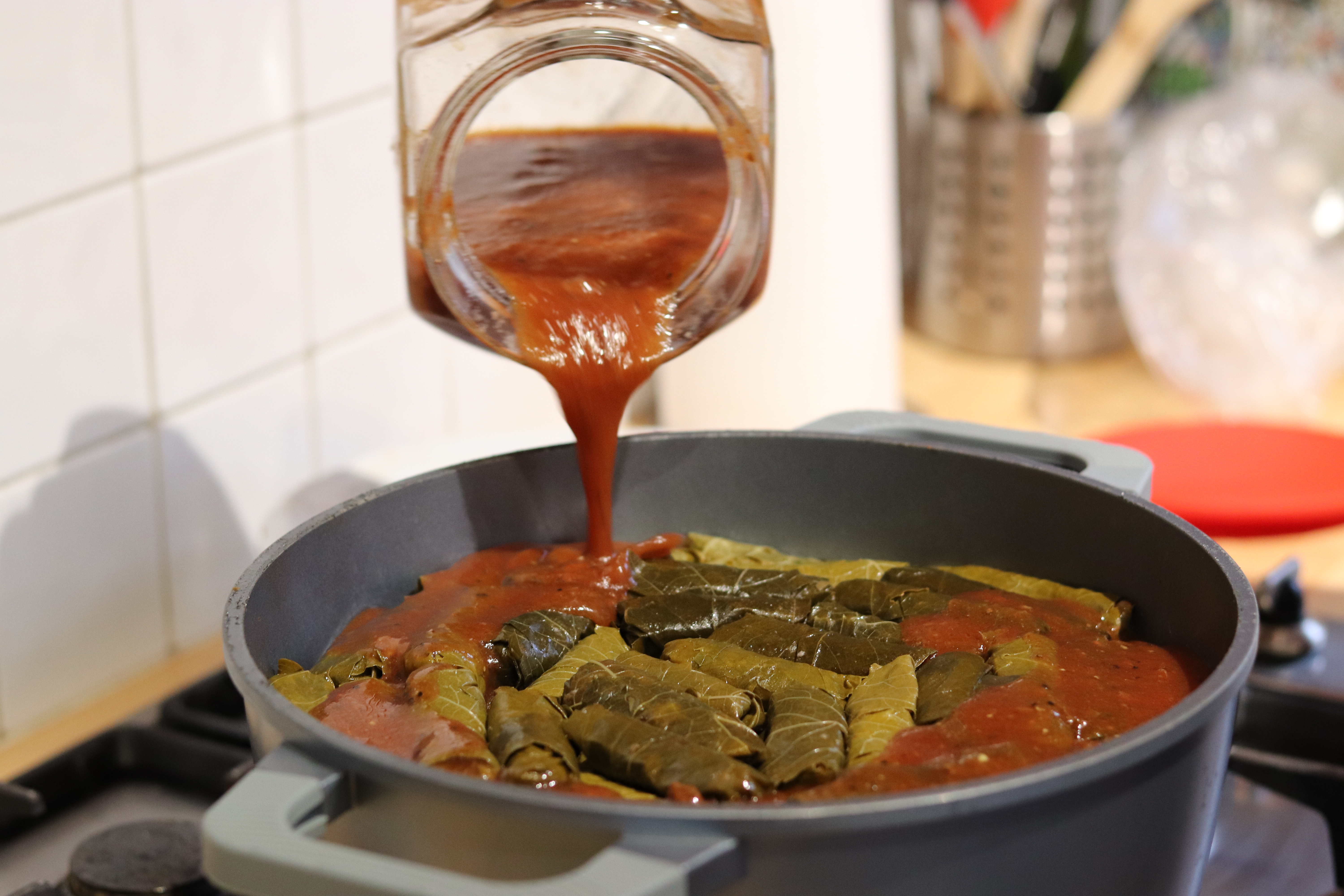 1550665338483-AA-Pouring-tomato-sauce-onto-dolma