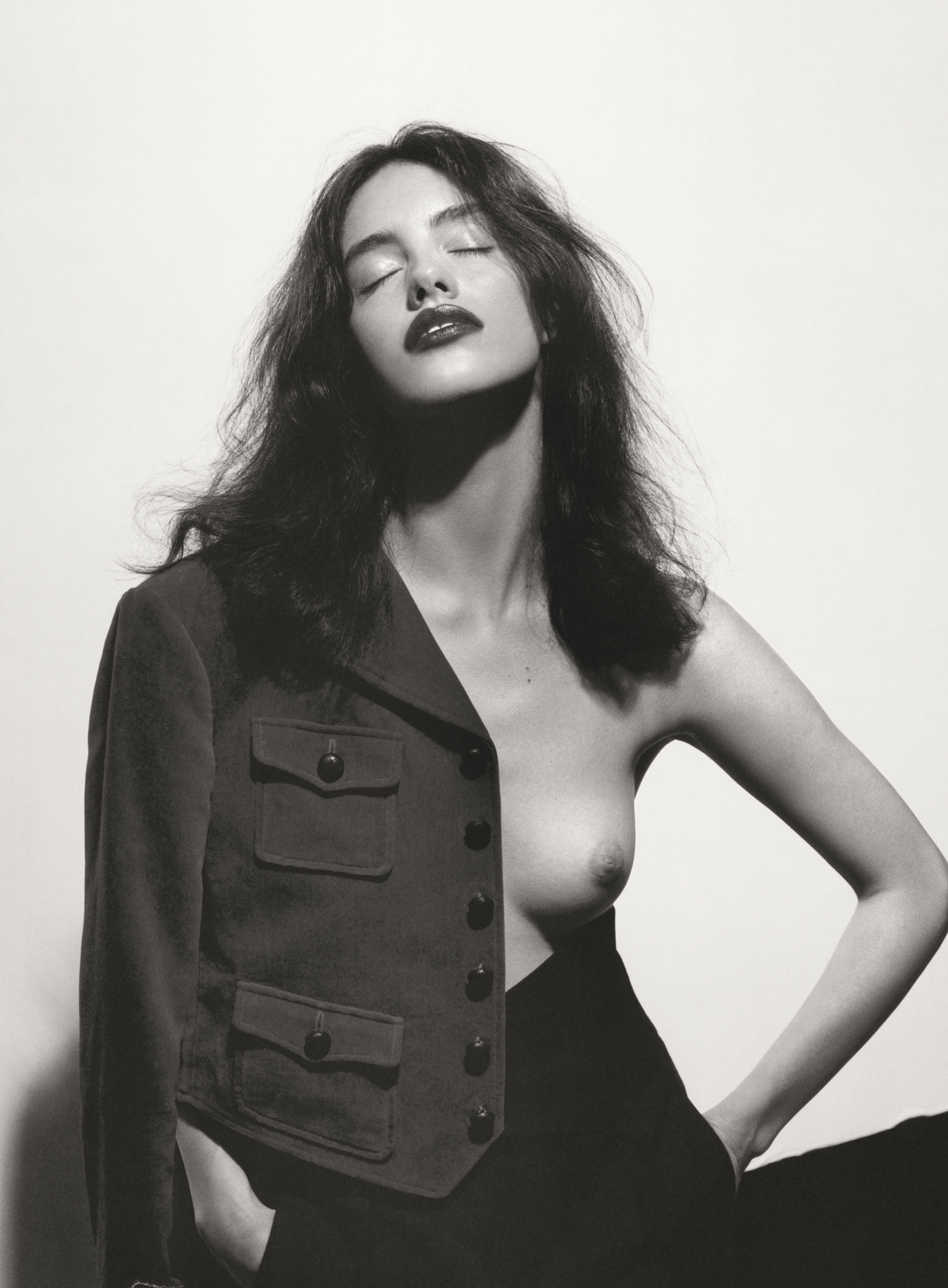 Nicole wears jacket and trousers by SAINT LAURENT.