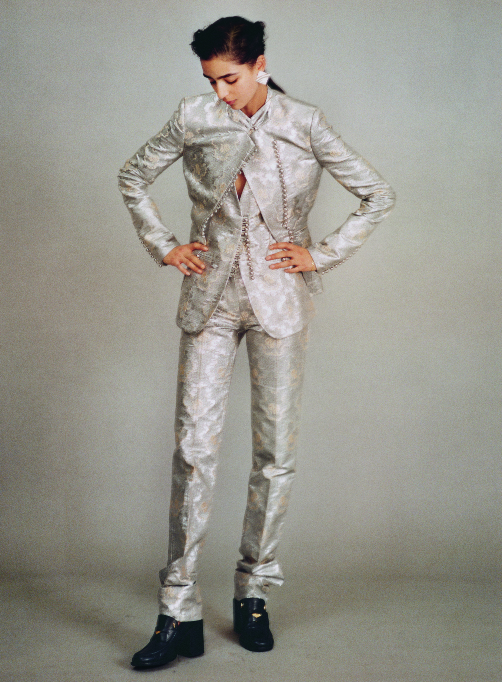 Jacket, dress, trousers, and shoes by PACO RABANNE, earrings by HORIZONS VINTAGE.