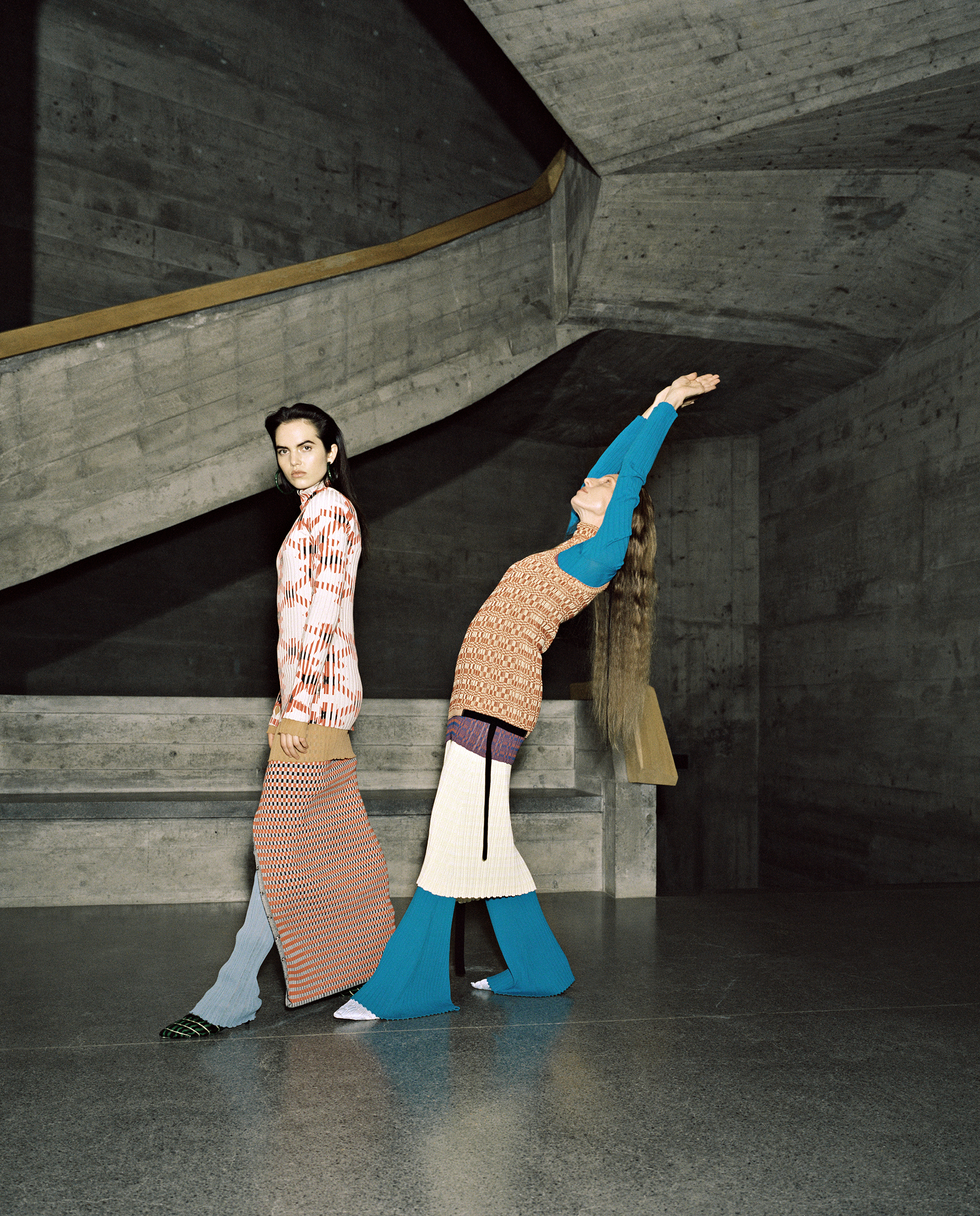 Lily (left) wears top and skirt by PACO RABANNE, pants and underpinning by ACNE STUDIOS, earrings by CULT GAIA; Martje (right) wears vest and skirt by JIL SANDER, shirt and trousers by ELLERY, earrings by CULT GAIA, all shoes by AMY CROOKES.