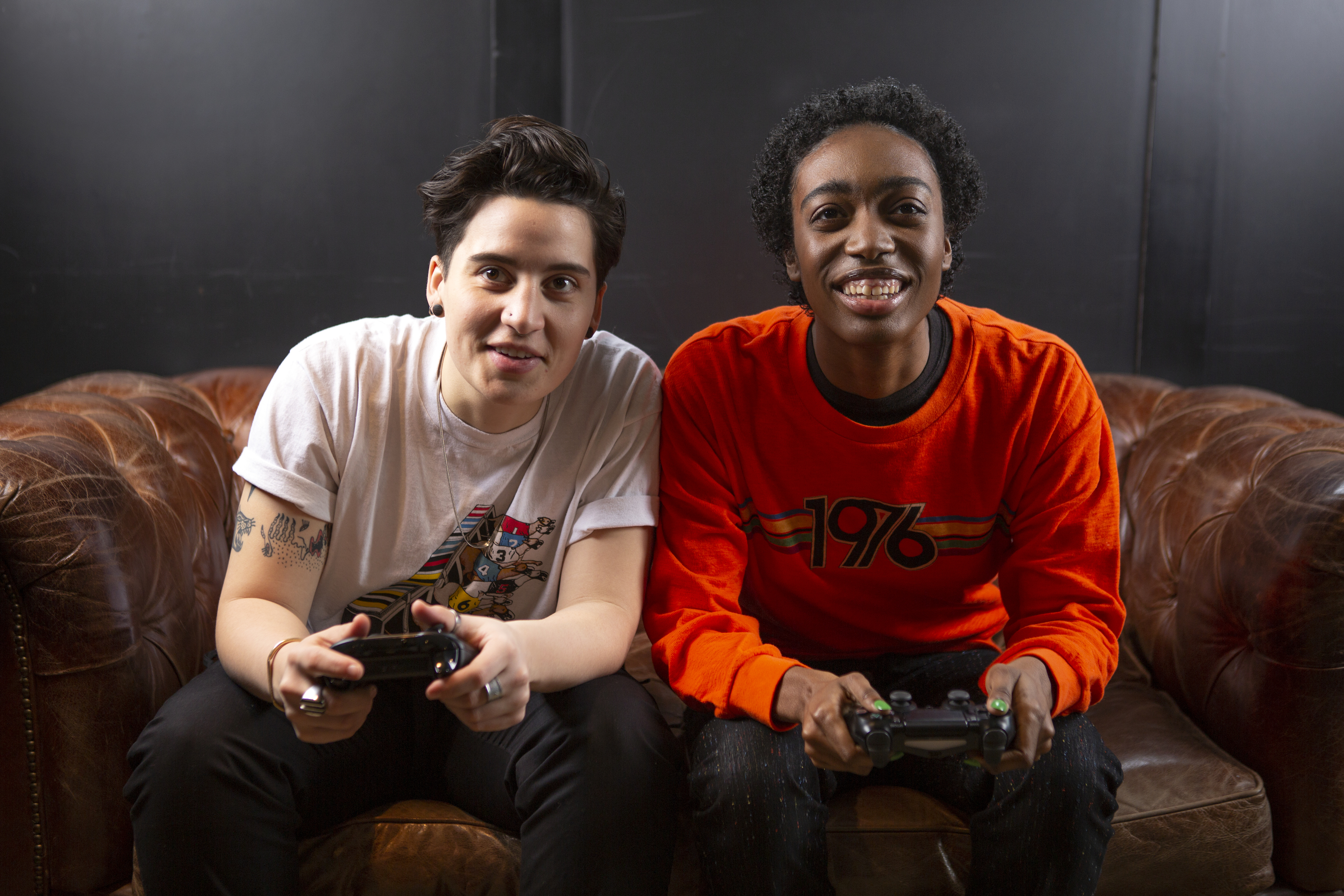 two non-binary friends playing video games