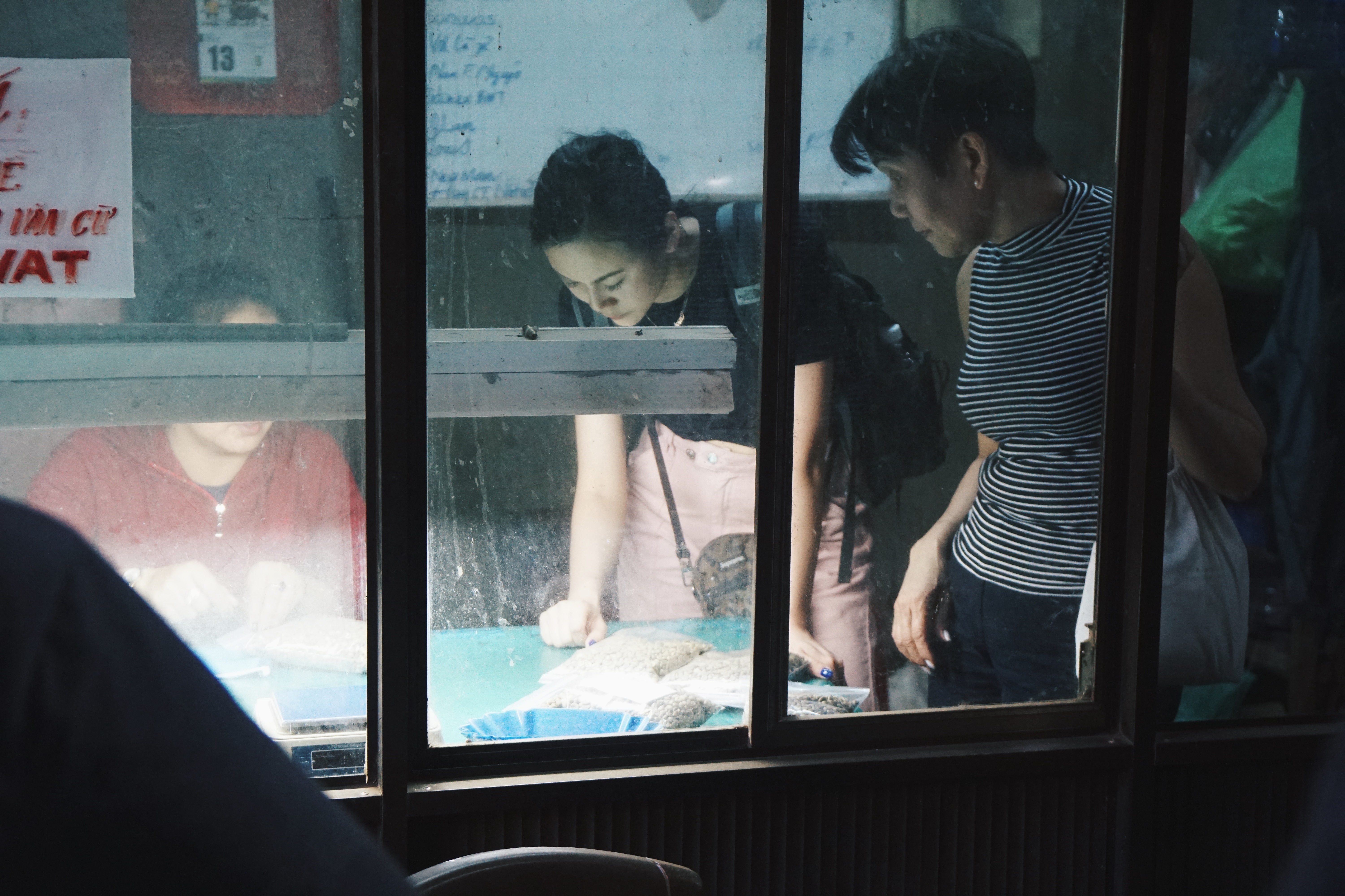 Sahra Nguyen and her mom looking at coffee beans with distributor