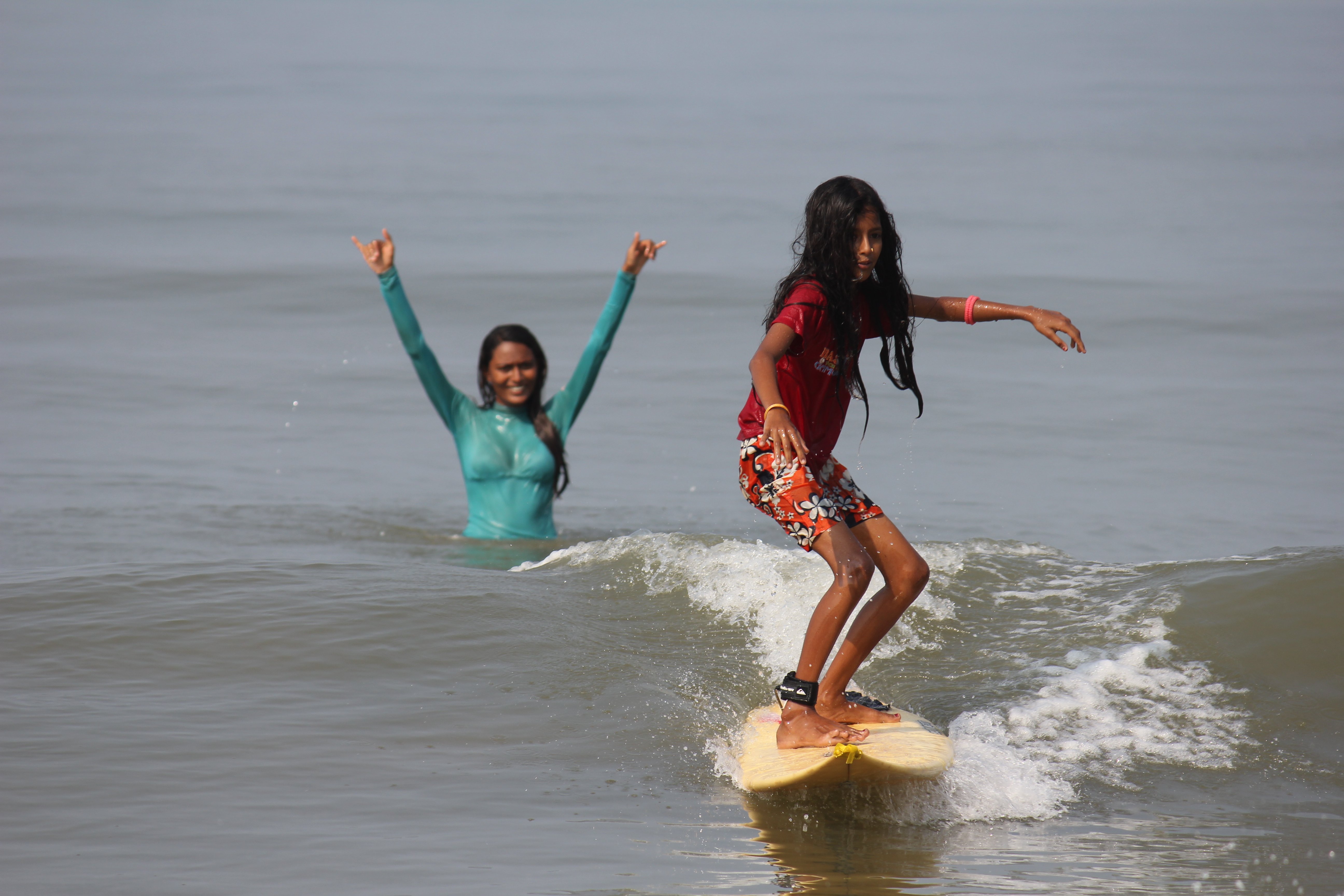 1554905463924-Ishita-teaching-local-girl-Tejaswini-how-to-surf