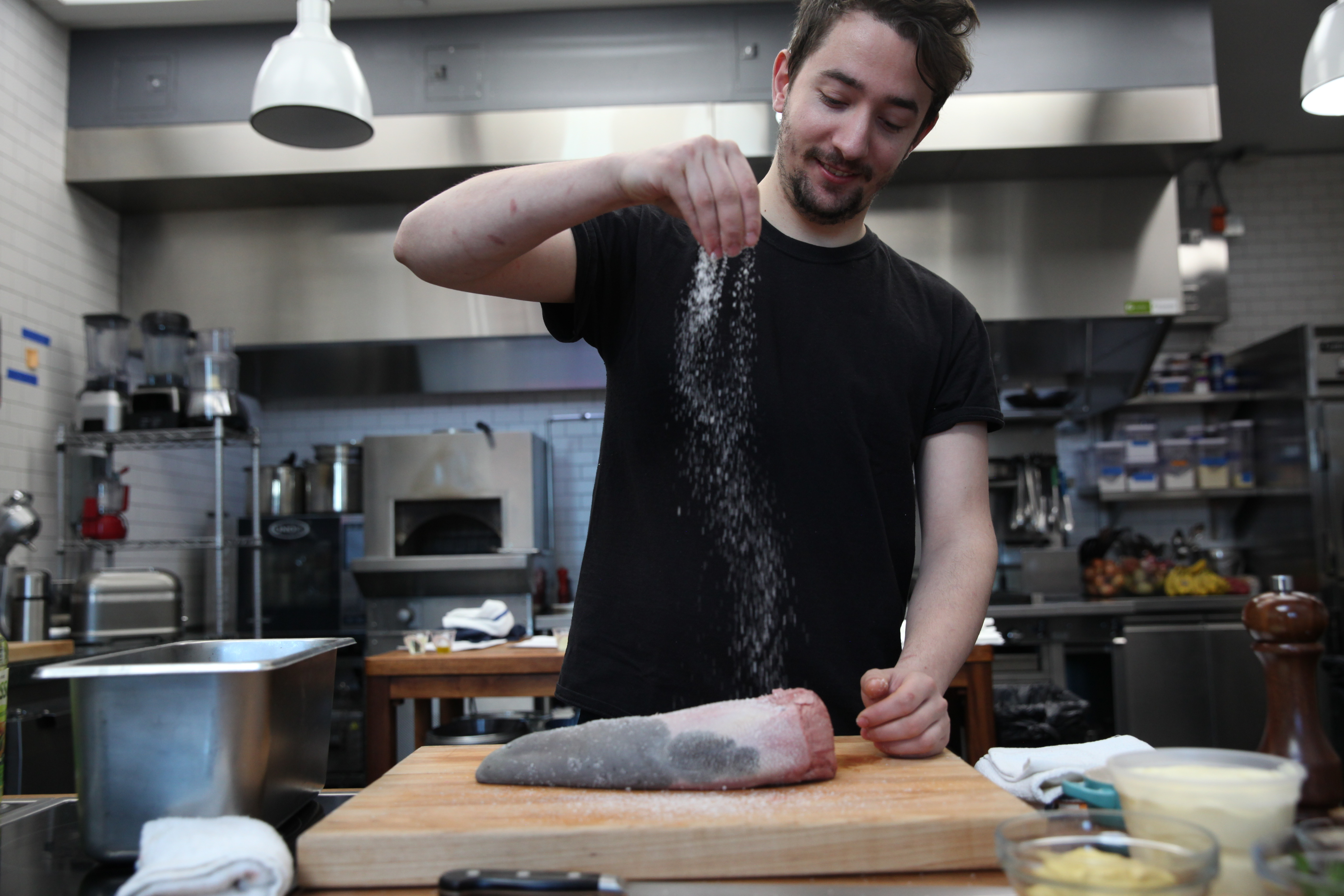 chef ed szymanski of cherry point salting a beef tongue