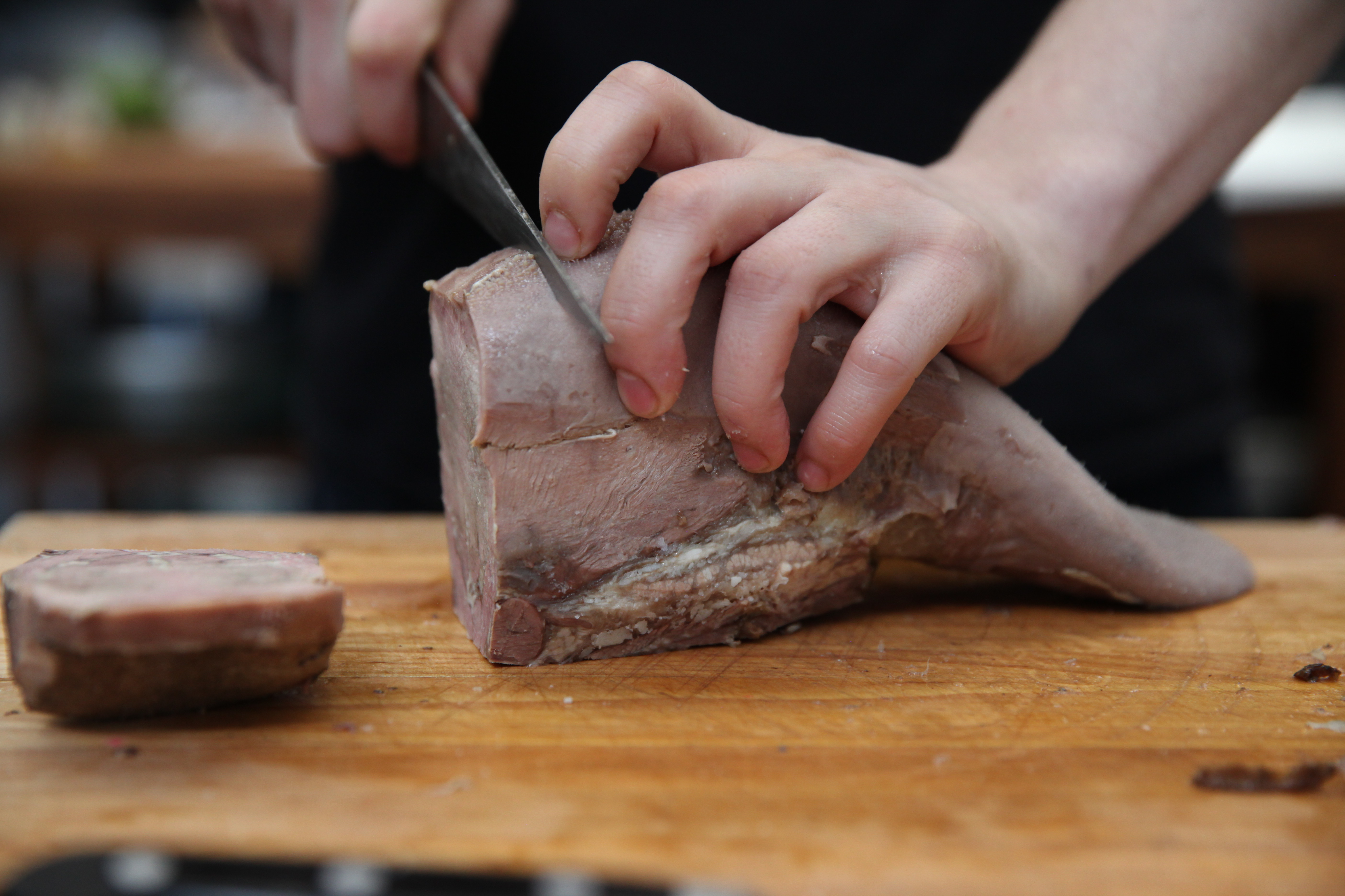 chef ed szymanski of cherry point slicing beef tongue