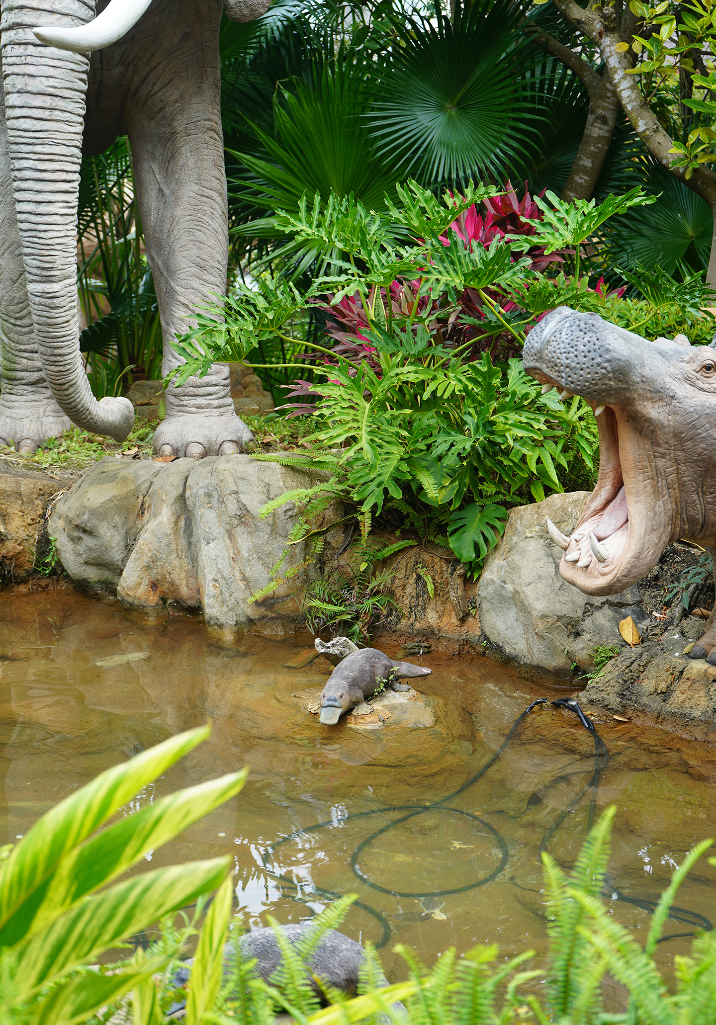 Fiberglass statues of a platypus, a hippo, and an elephant in the gardens of Noah's Ark Hong Kong