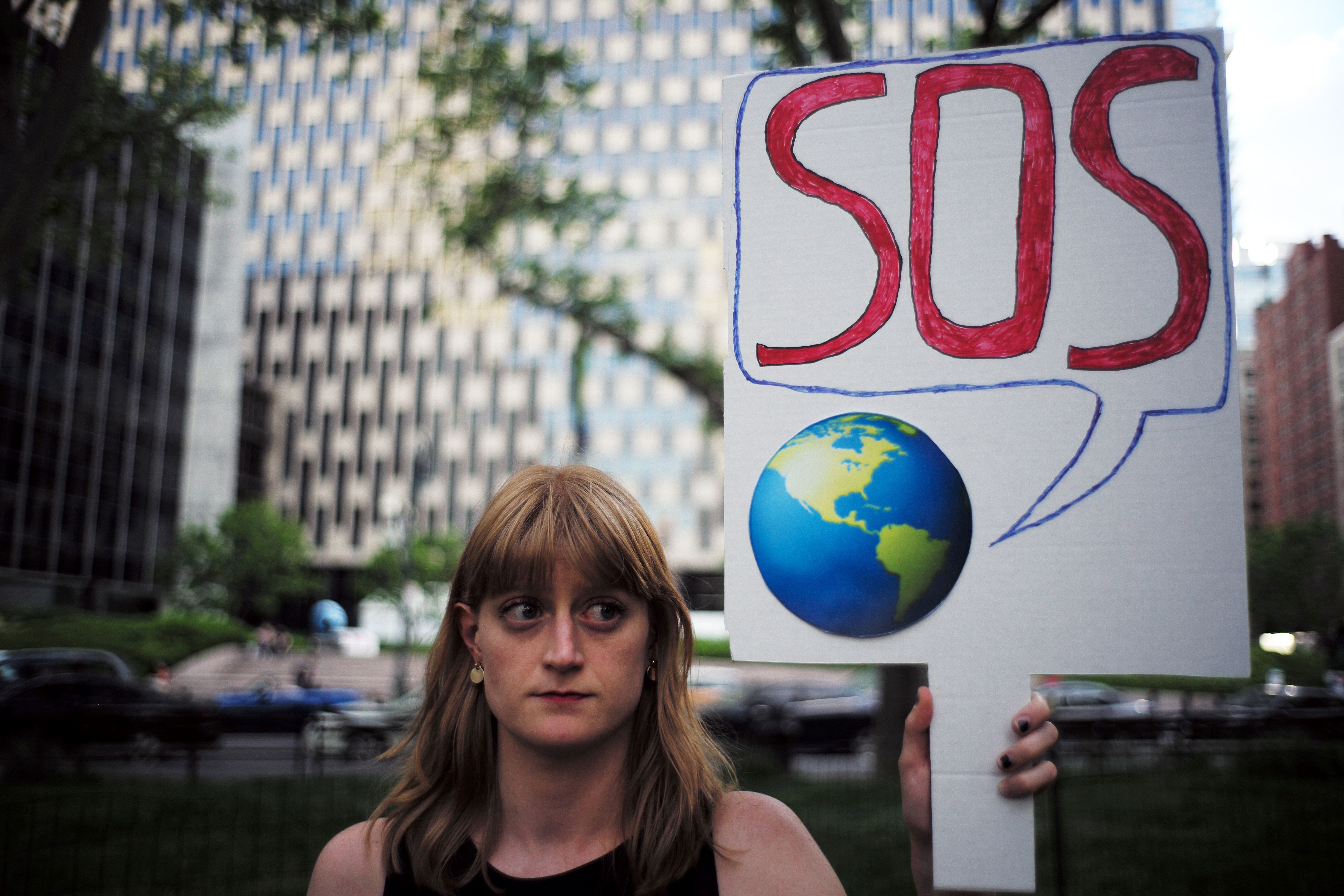 A climate protester holding up a sign.