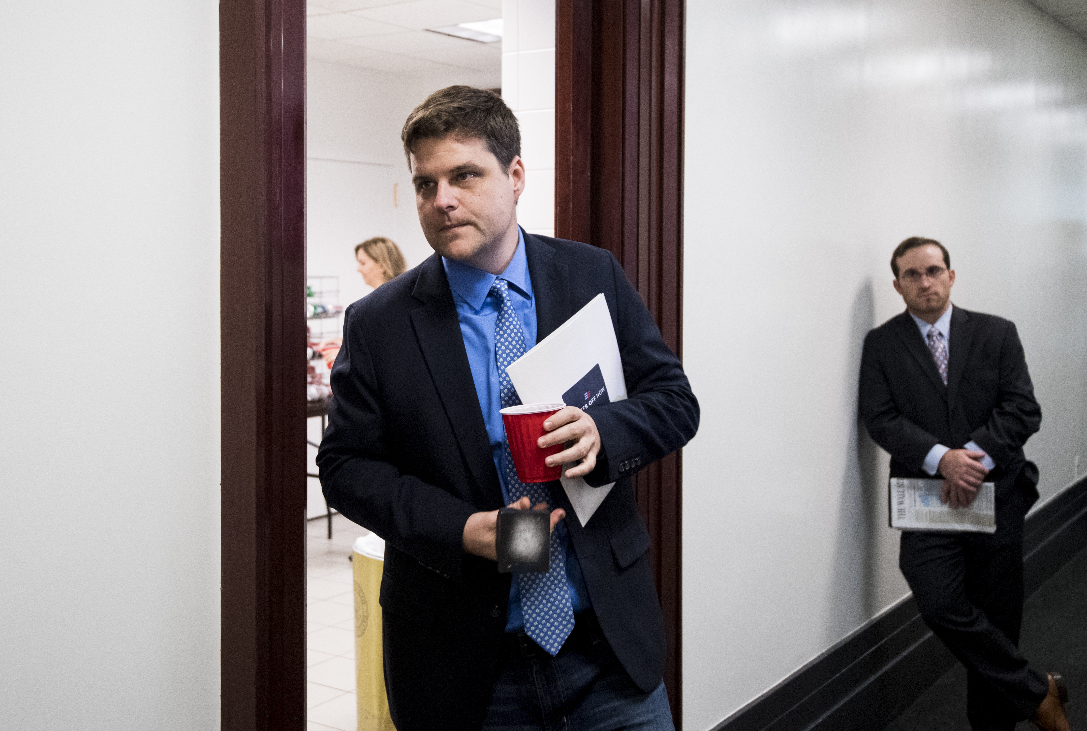 Congressman Matt Gaetz walking in a hallway.