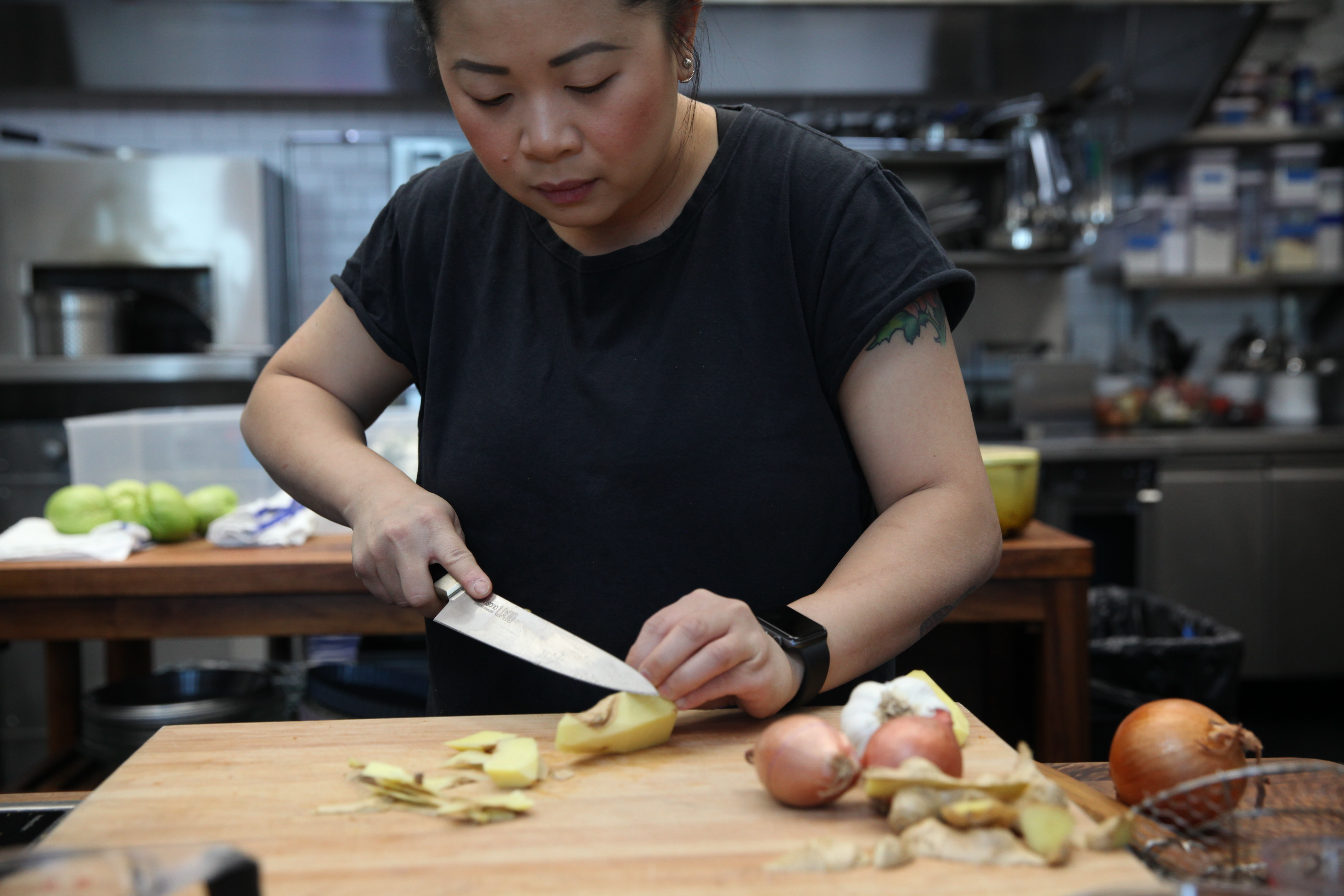 chef mei lin of nightshade restaurant in los angeles slicing ginger