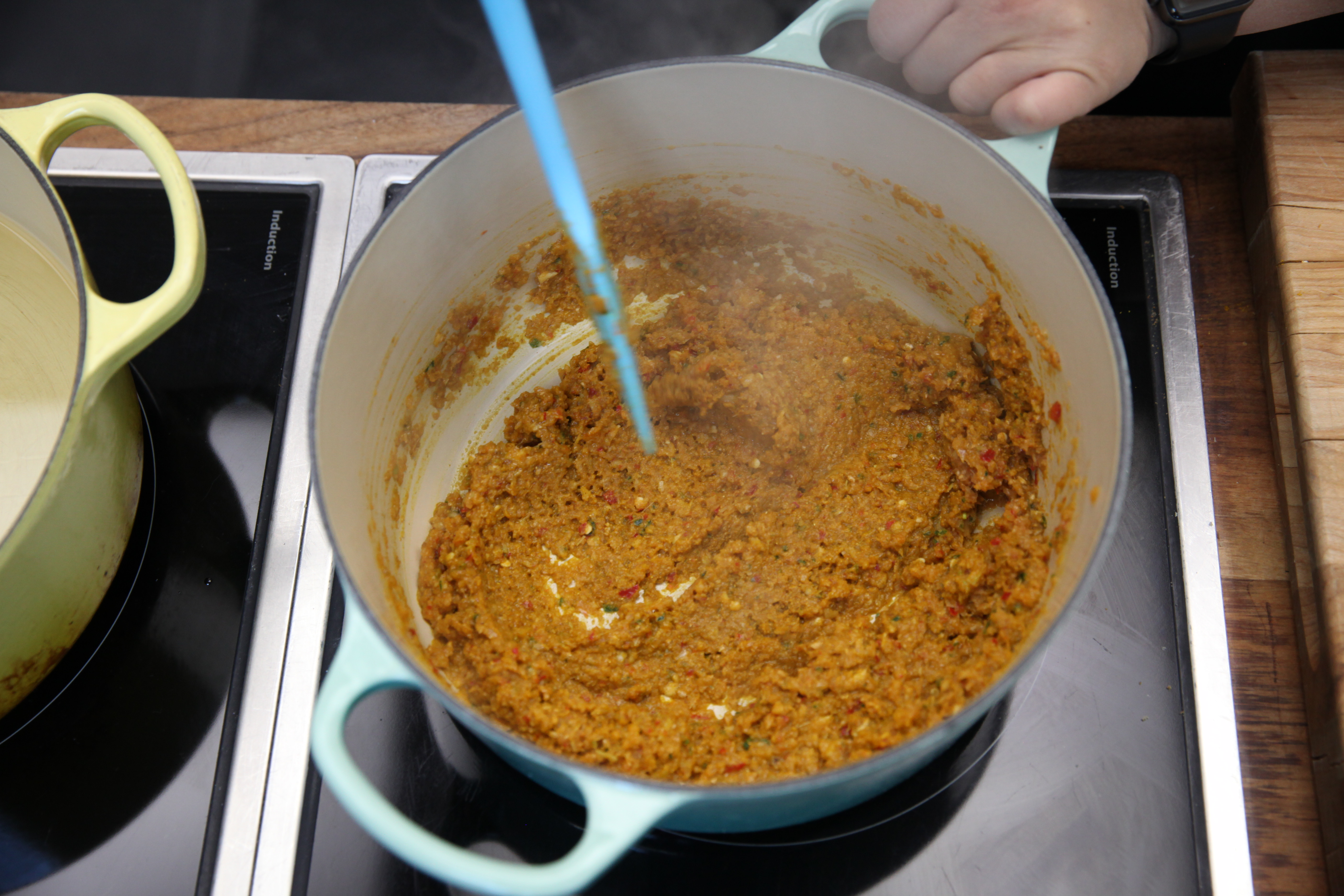 chef mei lin's cantonese curry paste cooking in a blue dutch oven