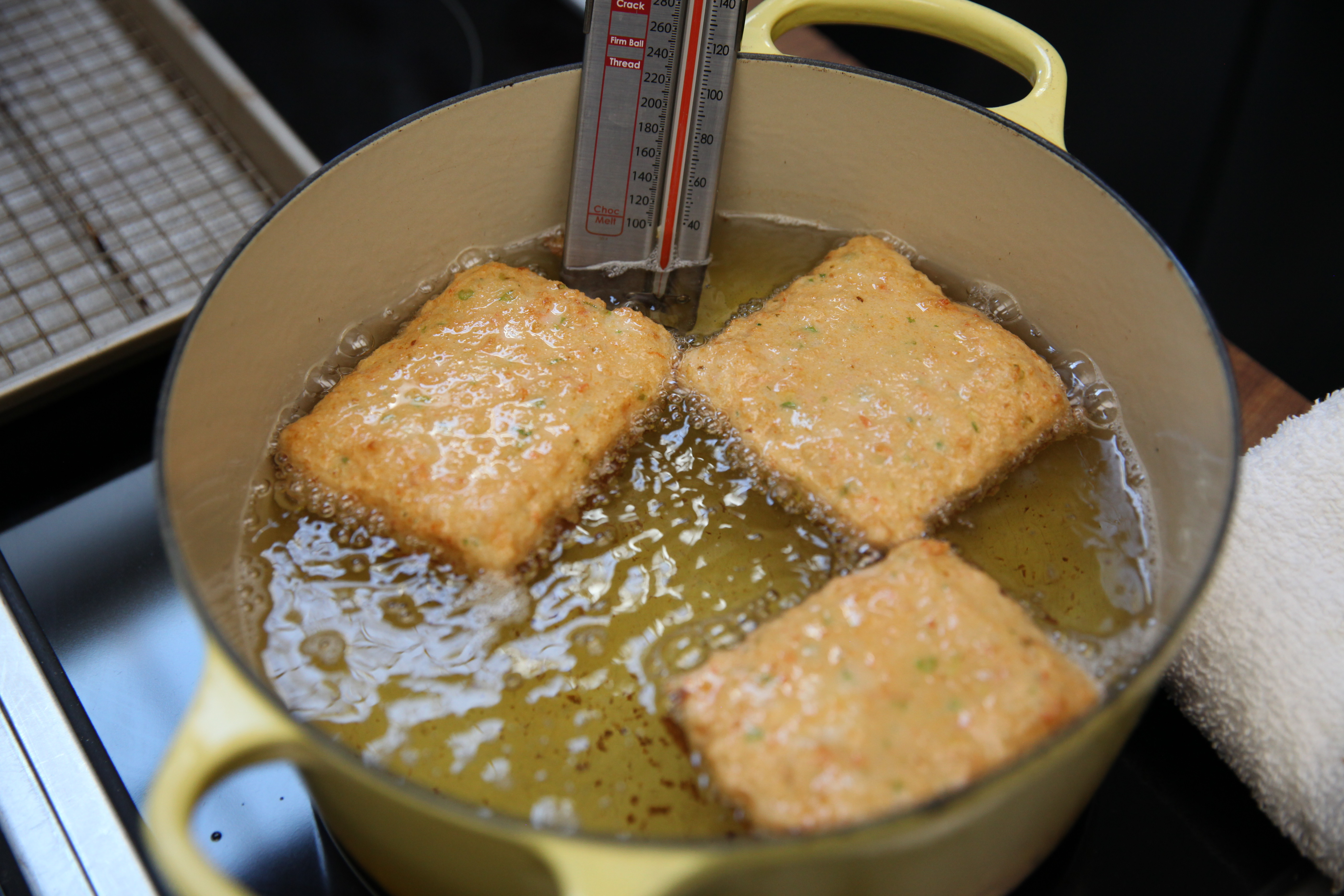 chef mei lin's shrimp toast frying in a yellow dutch oven full of oil