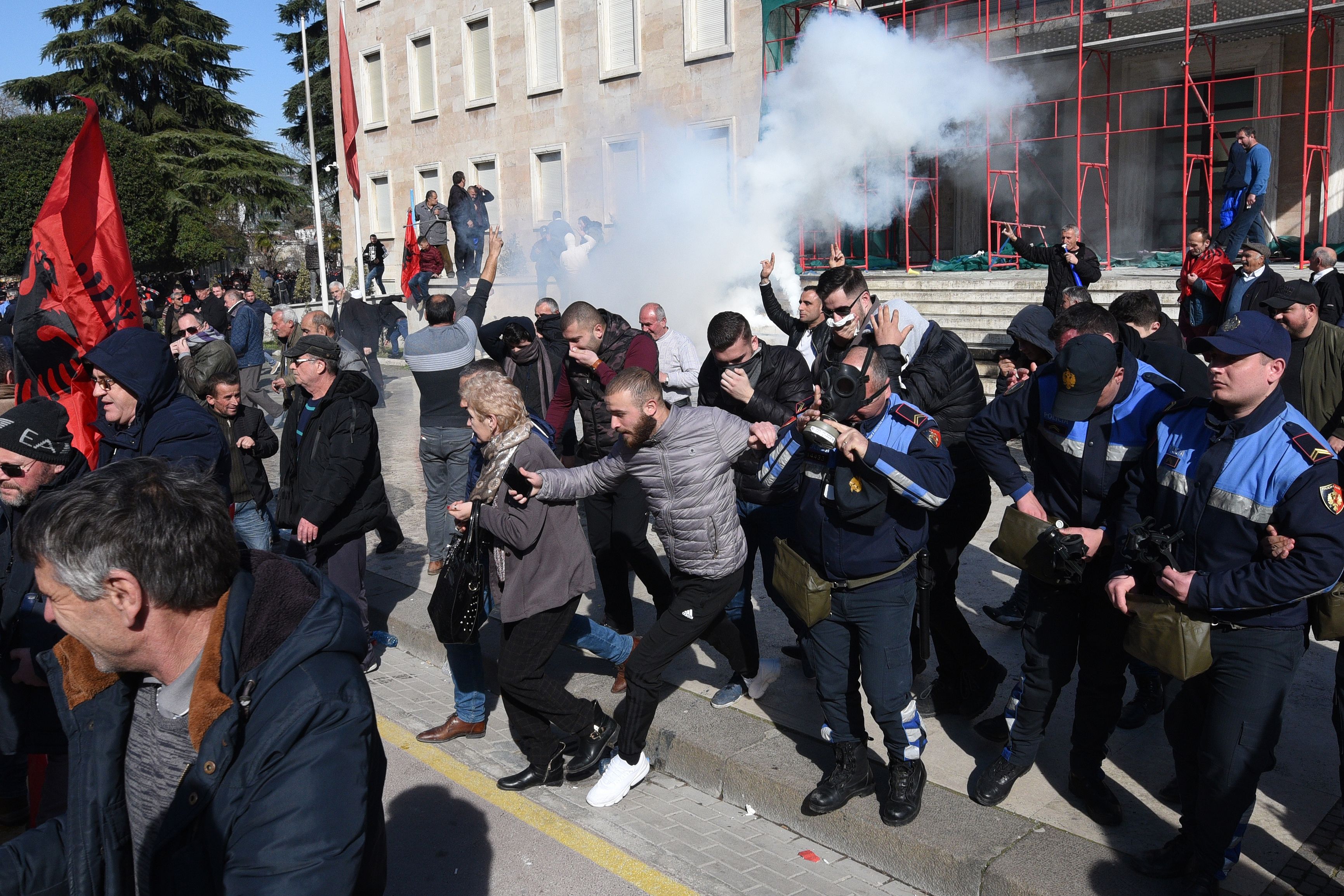 Protestors run from tear gas in Tirana, Albania during February protests calling for the resignation of the prime minister over corruption allegations.