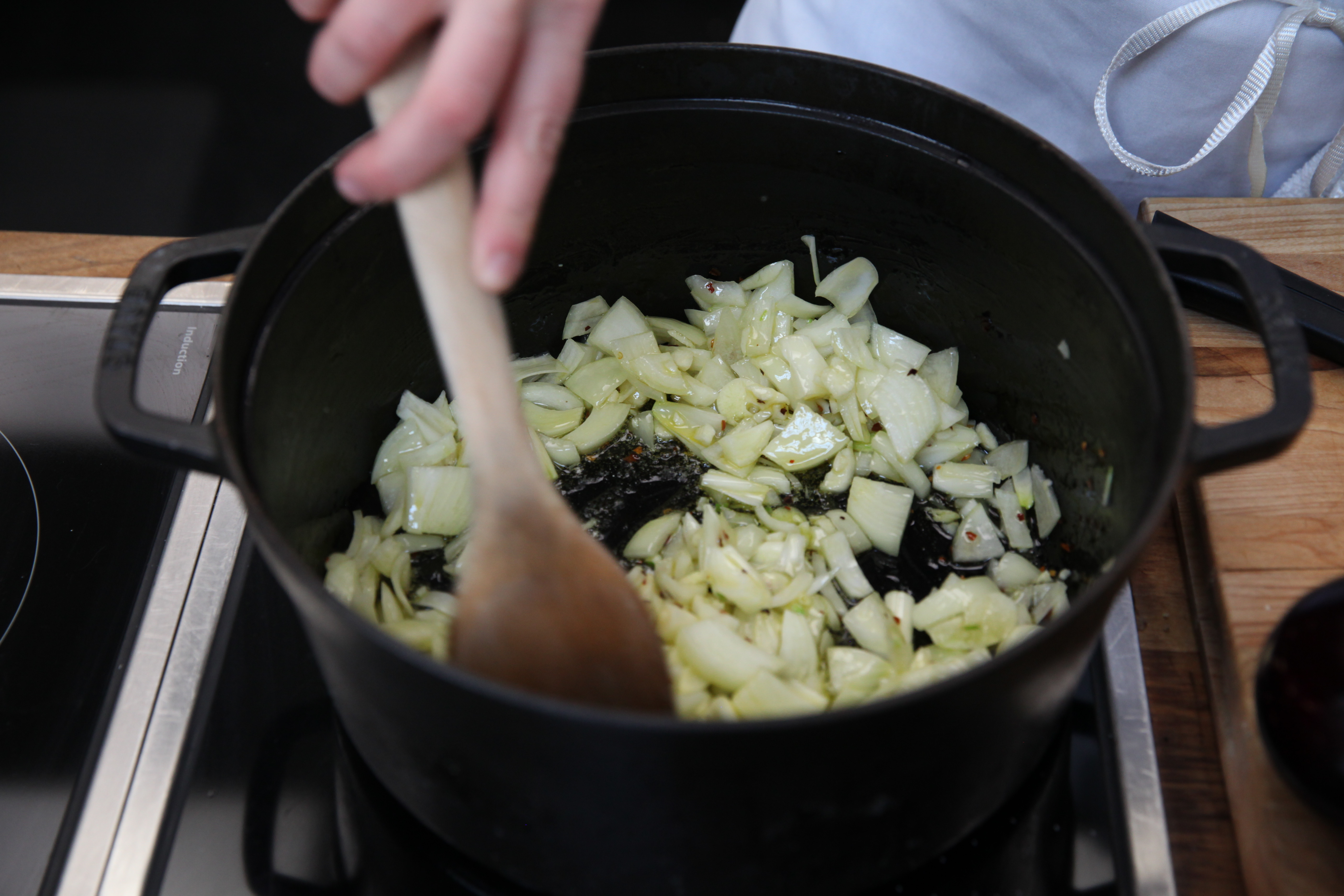 onions cooking in olive oil in a dutch oven