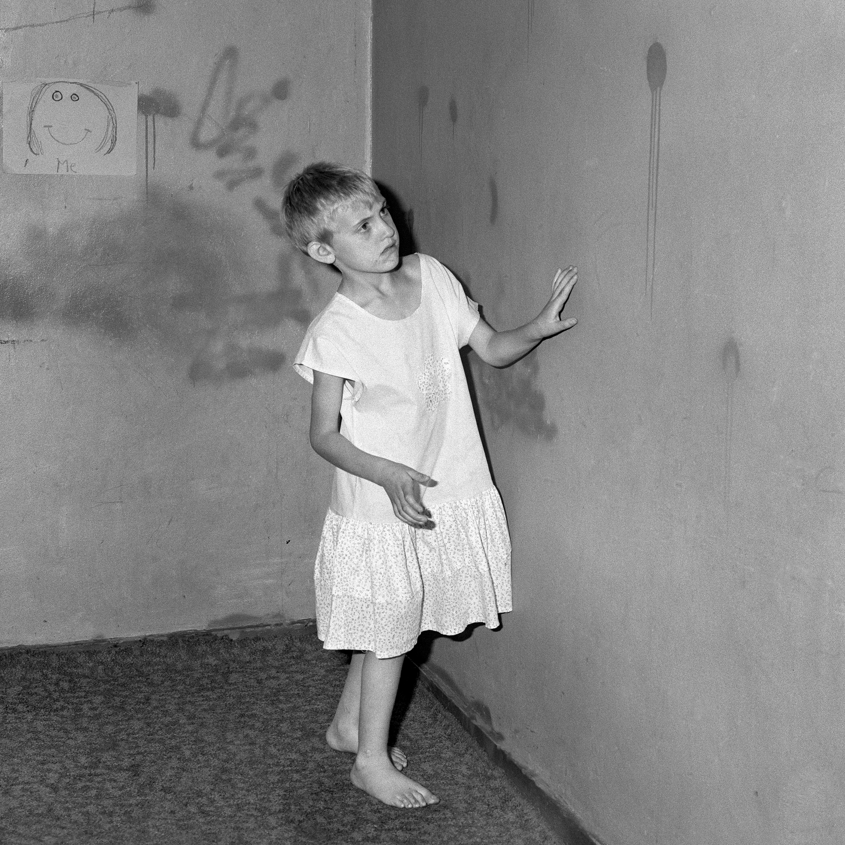 1560849271731-4_Roger-Ballen_Girl-in-white-dress_-2002