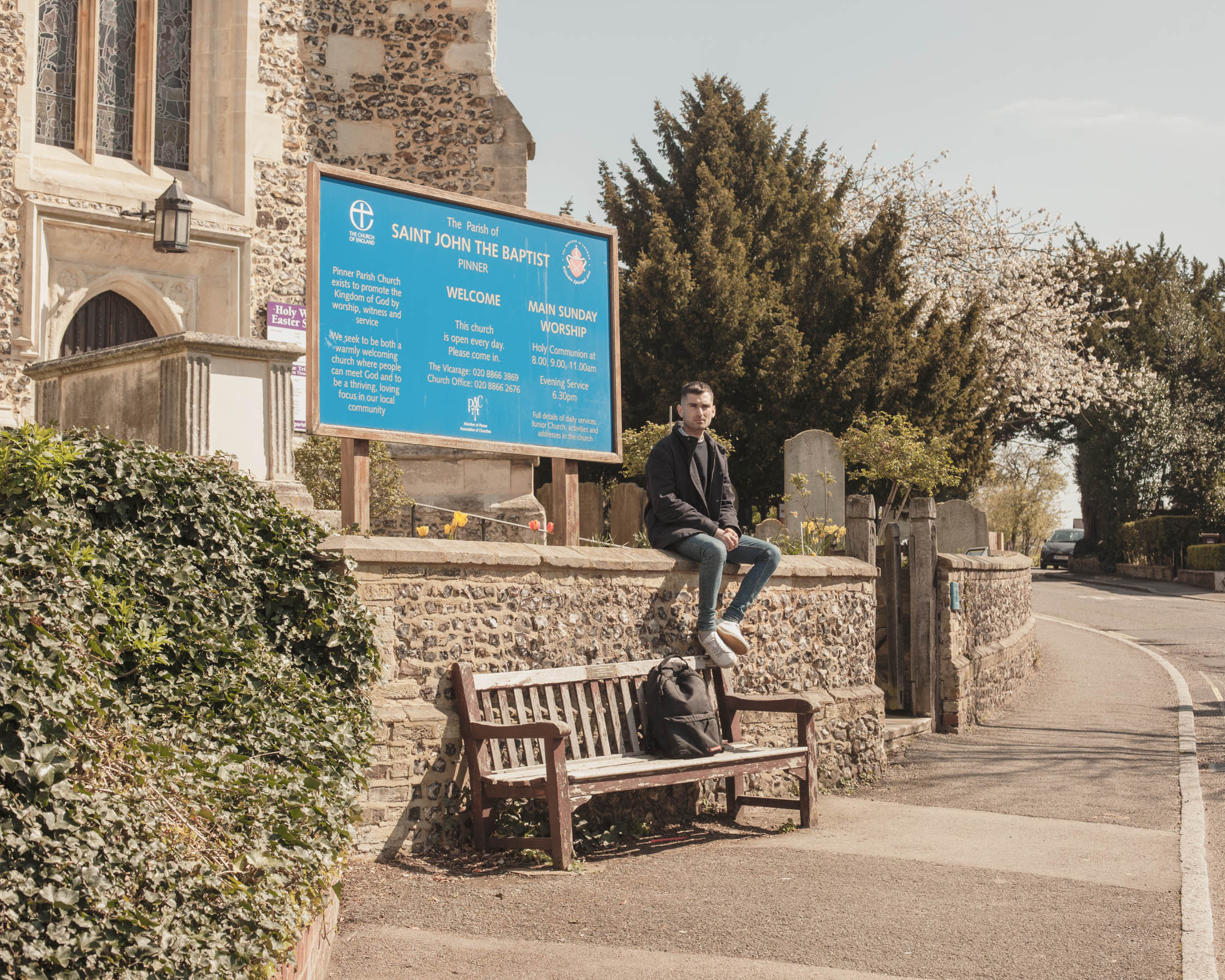 man sitting in front of church