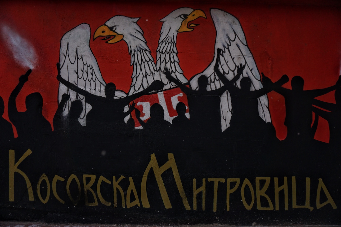 1562778626558-A-mural-in-the-center-of-the-northern-Kosovska-Mitrovica-It-was-painted-years-ago-and-has-slowly-became-the-symbol-of-the-northern-part-of-the-city