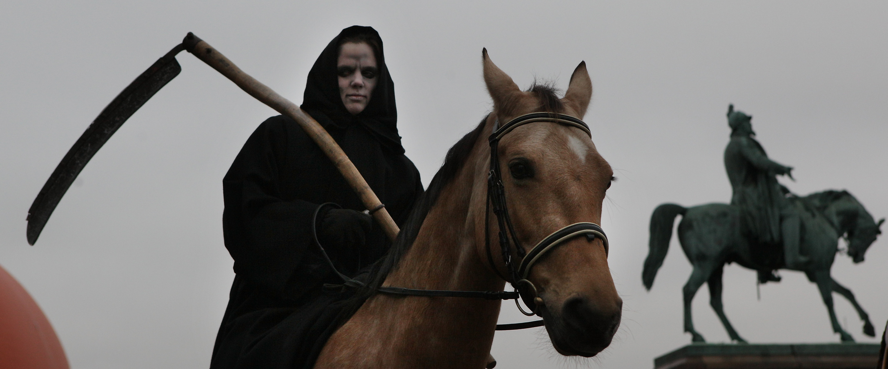 A protester dressed as Death on a horse.