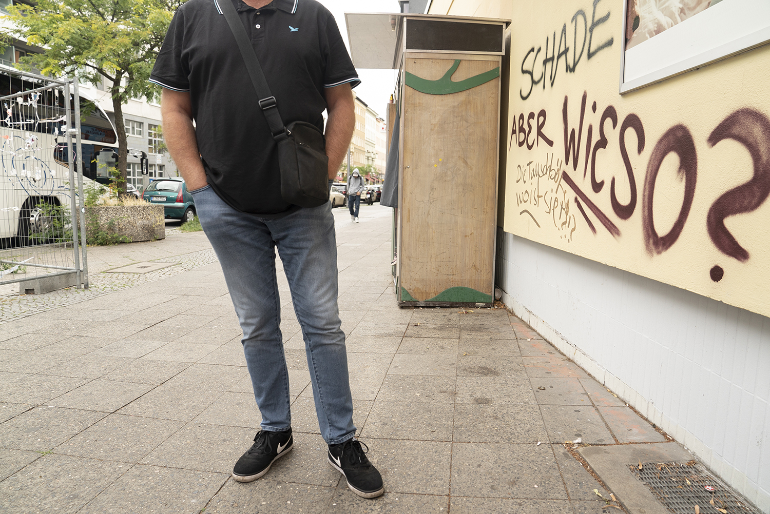 Ein Mann steht vor einer bemalten Wand