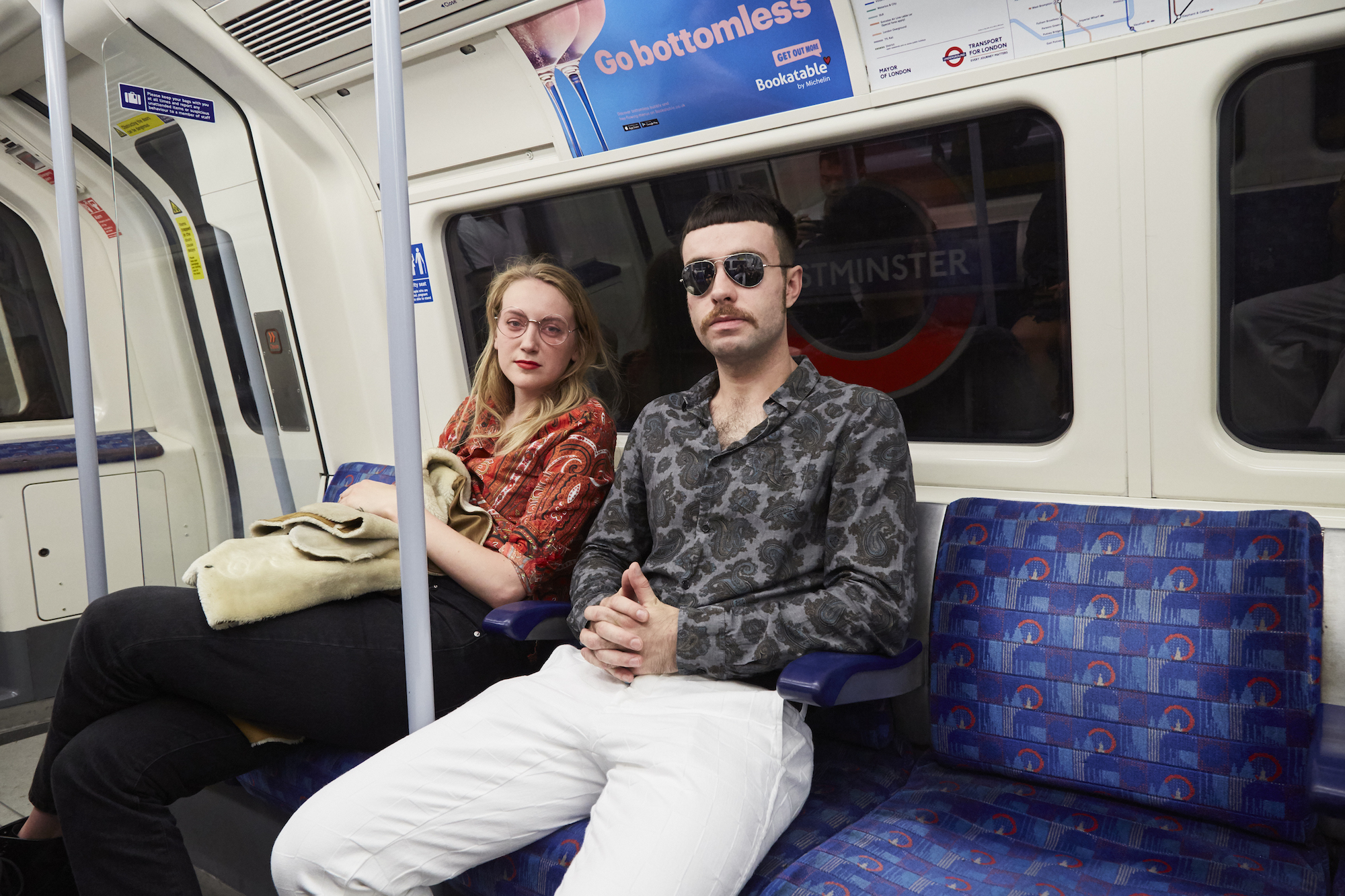 man in 70s clothing on tube